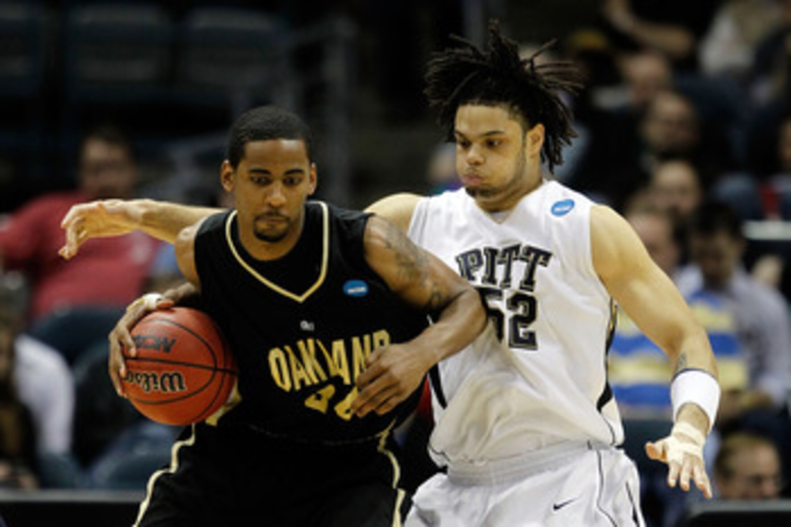 MILWAUKEE - MARCH 19:  Keith Benson #34 of the Oakland Golden Grizzlies posts up Gary McGhee #52 of the Pittsburgh Panthers in the second half during the first round of the 2010 NCAA men's basketball tournament at the Bradley Center on March 19, 2010 in M