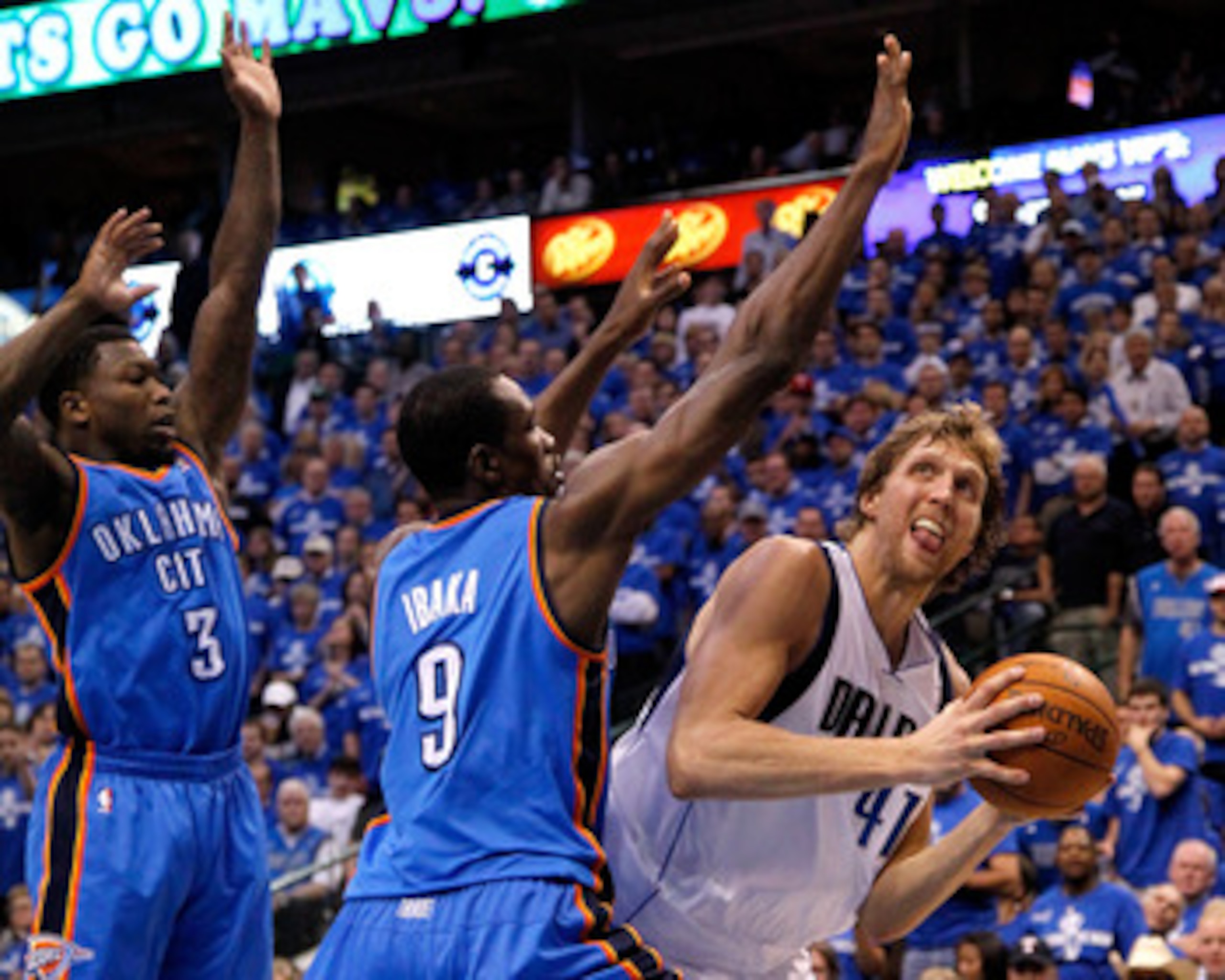 DALLAS, TX - MAY 17:  Dirk Nowitzki #41 of the Dallas Mavericks looks to shoot over Serge Ibaka #9 and Nate Robinson #3 of the Oklahoma City Thunder in Game One of the Western Conference Finals during the 2011 NBA Playoffs at American Airlines Center on M