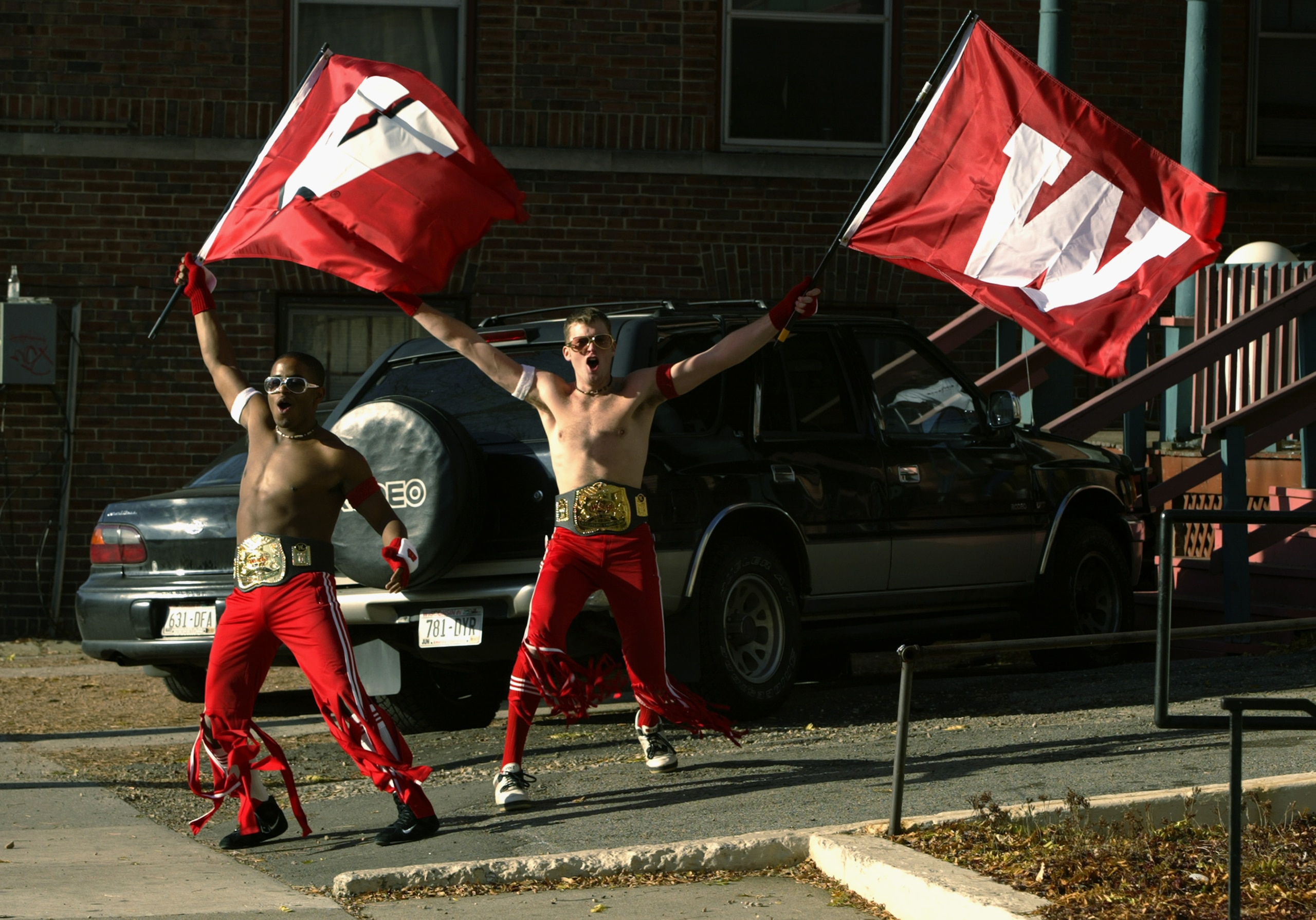MADISON, WI - NOVEMBER 9:  Students Reggie Williams, left, and Andrew Muehlenberg try to rile up fans en route to the Big Ten Conference football game between the Wisconsin Badgers and the Illinois Fighting Illini at Camp Randall Stadium on November 9, 20