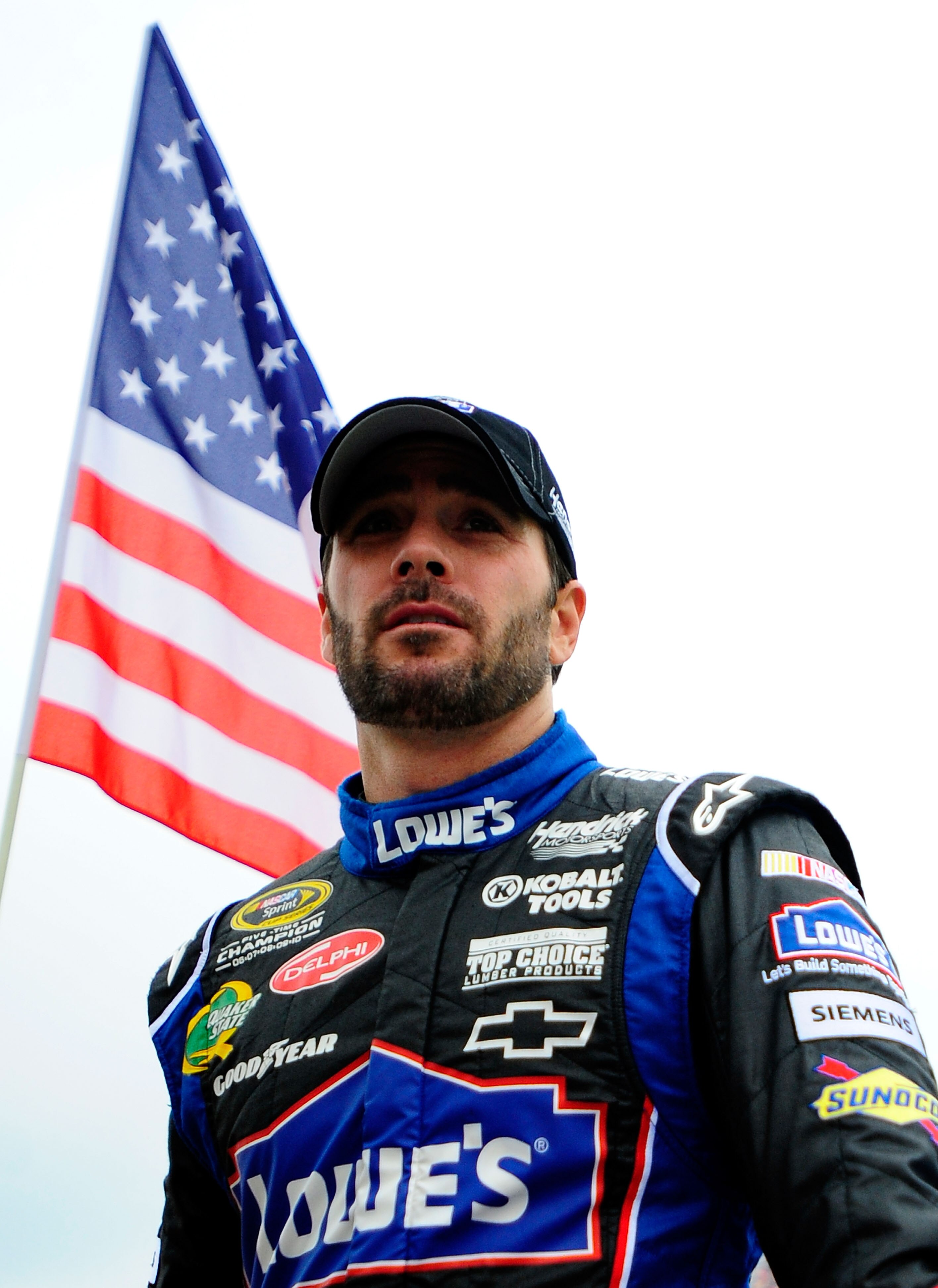 DOVER, DE - MAY 15:  Jimmie Johnson, driver of the #48 Lowe's Chevrolet, stands on the grid prior to the NASCAR Sprint Cup Series FedEx 400 Benefiting Autism Speaks at Dover International Speedway on May 15, 2011 in Dover, Delaware.  (Photo by Jason Smith