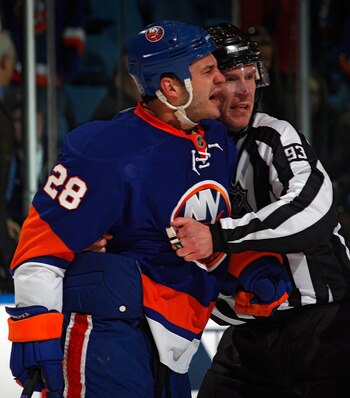 UNIONDALE, NY - MARCH 24:  Zenon Konopka #28 of the New York Islanders is restrained by linesman Brian Murphy #93 during a fight in an NHL hockey game against the Atlanta Thrashers at the Nassau Coliseum on March 24, 2011 in Uniondale, New York.  (Photo b