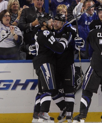 TAMPA, FL - MAY 03: Dominic Moore #19 hugs Sean Bergenheim #10 of the Tampa Bay Lightning following Bergenheim's first period goal against the Washington Capitals in Game Three of the Eastern Conference Semifinals during the 2011 NHL Stanley Cup Playoffs 