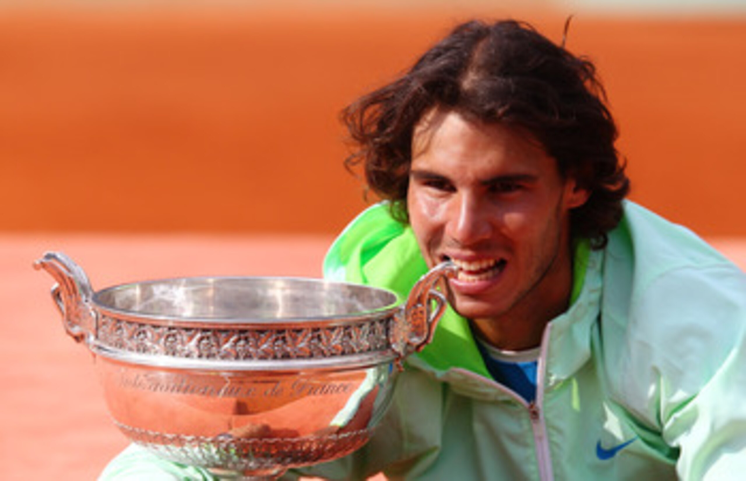 PARIS - JUNE 06: Rafael Nadal of Spain celebrates with the trophy after winning the men's singles final match between Rafael Nadal of Spain and Robin Soderling of Sweden on day fifteen of the French Open at Roland Garros on June 6, 2010 in Paris, France. PARIS - JUNE 06: Rafael Nadal of Spain celebrates with the trophy after winning the men's singles final match between Rafael Nadal of Spain and Robin Soderling of Sweden on day fifteen of the French Open at Roland Garros on June 6, 2010 in Paris, France.