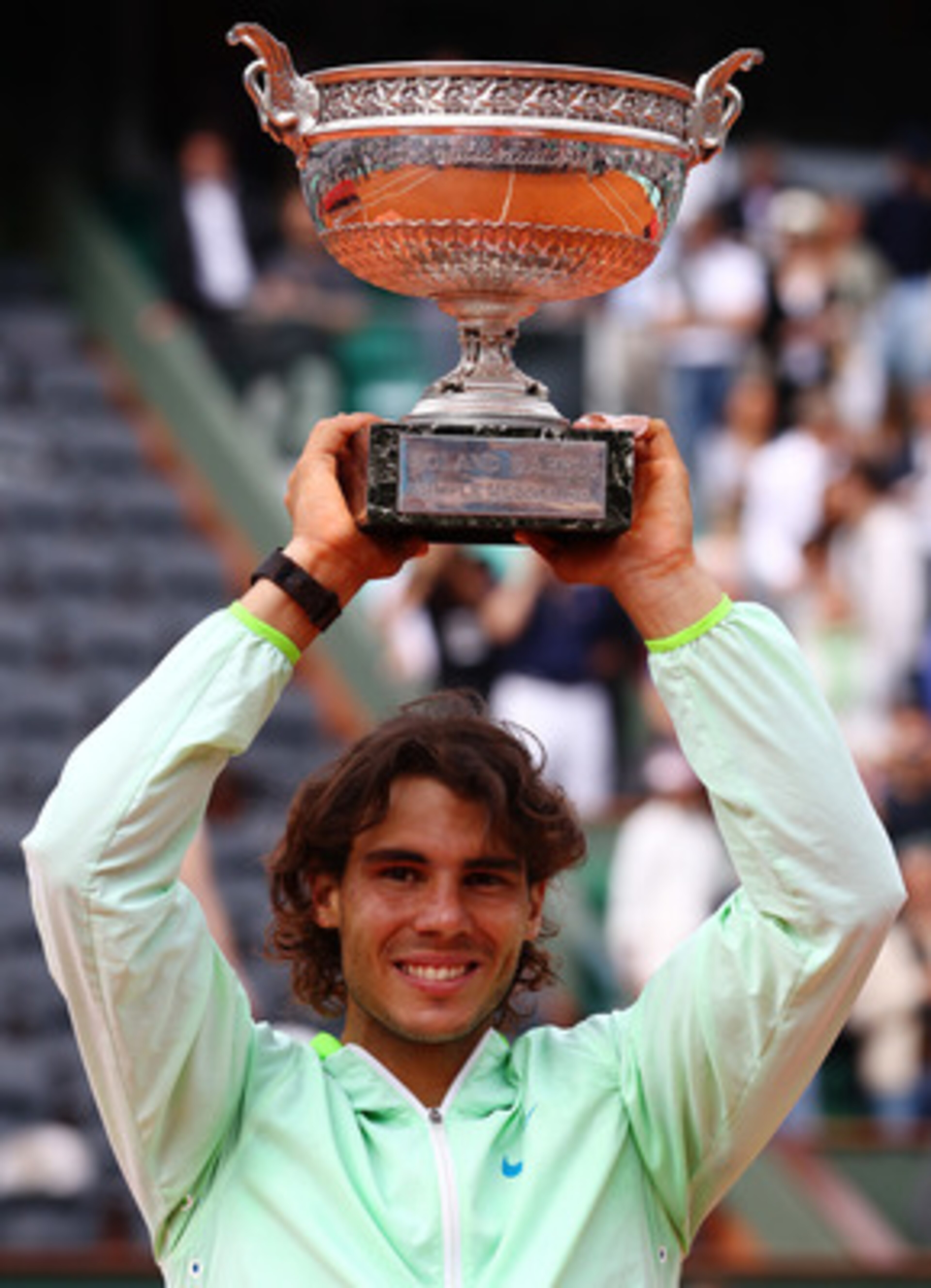 PARIS - JUNE 06:  Rafael Nadal of Spain celebrates with the trophy after winning the men's singles final match between Rafael Nadal of Spain and Robin Soderling of Sweden on day fifteen of the French Open at Roland Garros on June 6, 2010 in Paris, France.