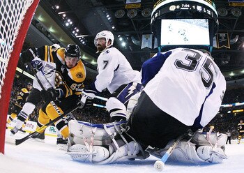 BOSTON, MA - MAY 17:  Brad Marchand #63 of the Boston Bruins shoots against the defense of Brett Clark #7 and Dwayne Roloson #35 of the Tampa Bay Lightning in Game Two of the Eastern Conference Finals during the 2011 NHL Stanley Cup Playoffs at TD Garden 