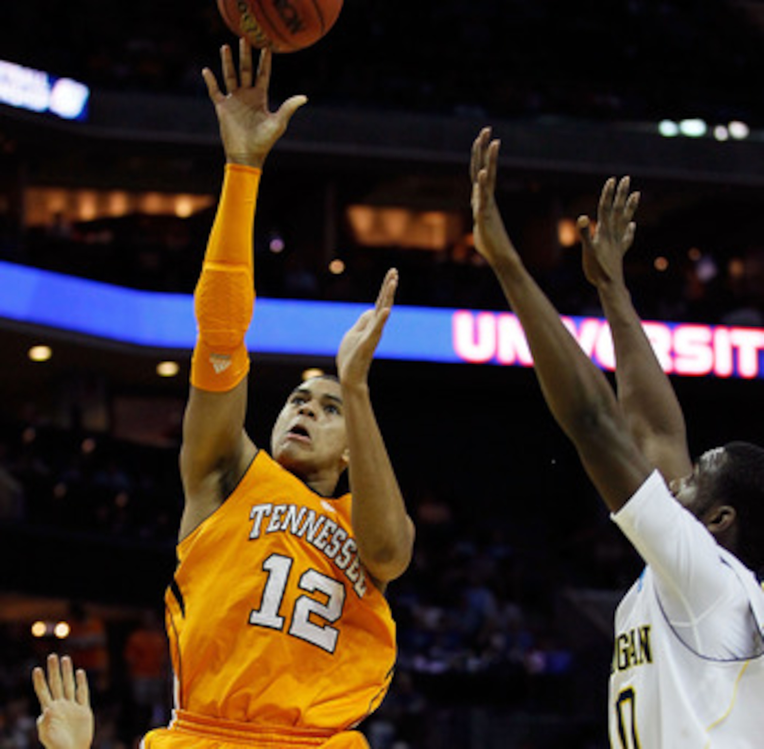 CHARLOTTE, NC - MARCH 18:  Tobias Harris #12 of the Tennessee Volunteers shoots over Tim Hardaway Jr. #10 of the Michigan Wolverines in the first half during the second round of the 2011 NCAA men's basketball tournament at Time Warner Cable Arena on March
