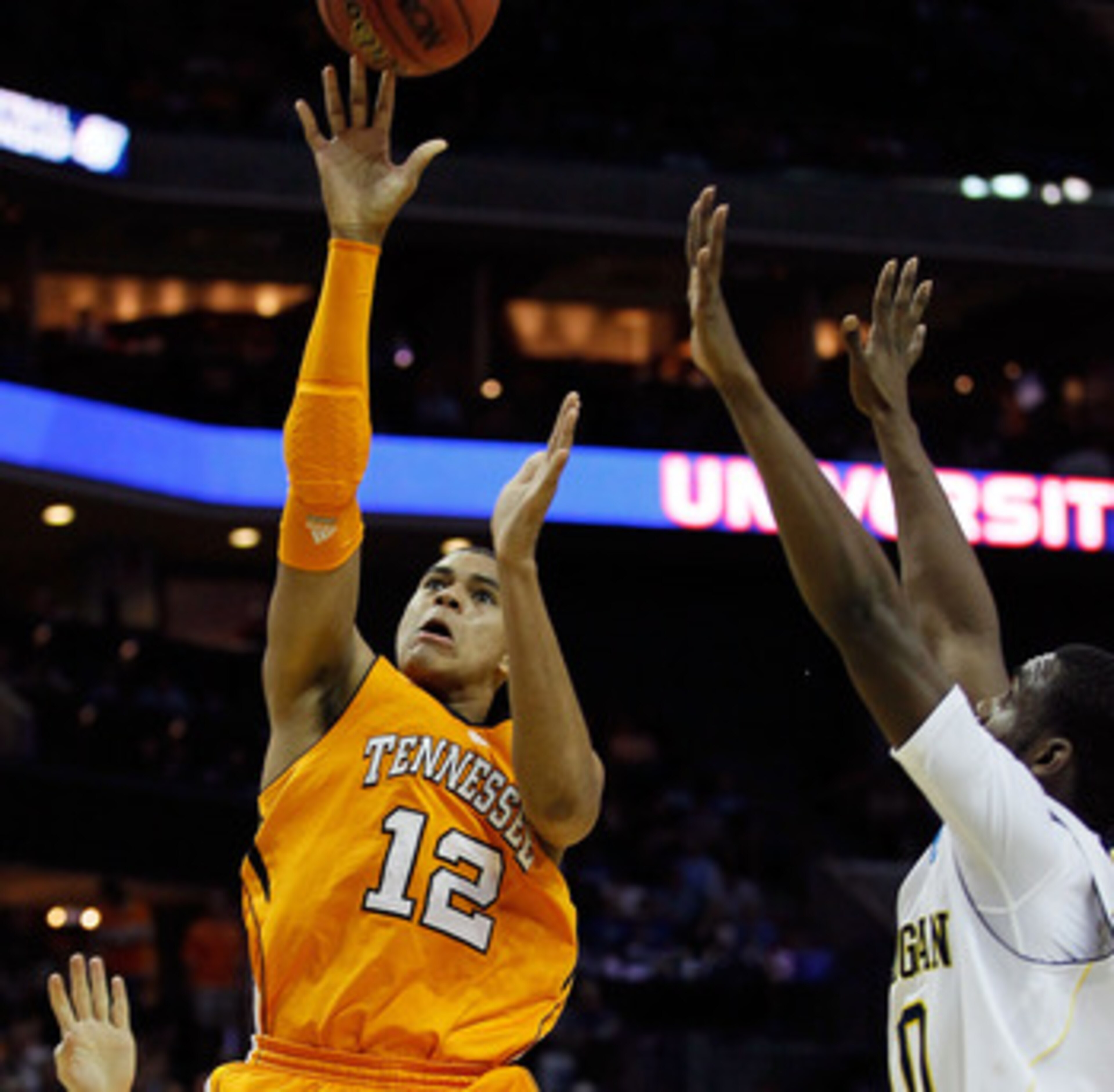 CHARLOTTE, NC - MARCH 18:  Tobias Harris #12 of the Tennessee Volunteers shoots over Tim Hardaway Jr. #10 of the Michigan Wolverines in the first half during the second round of the 2011 NCAA men's basketball tournament at Time Warner Cable Arena on March