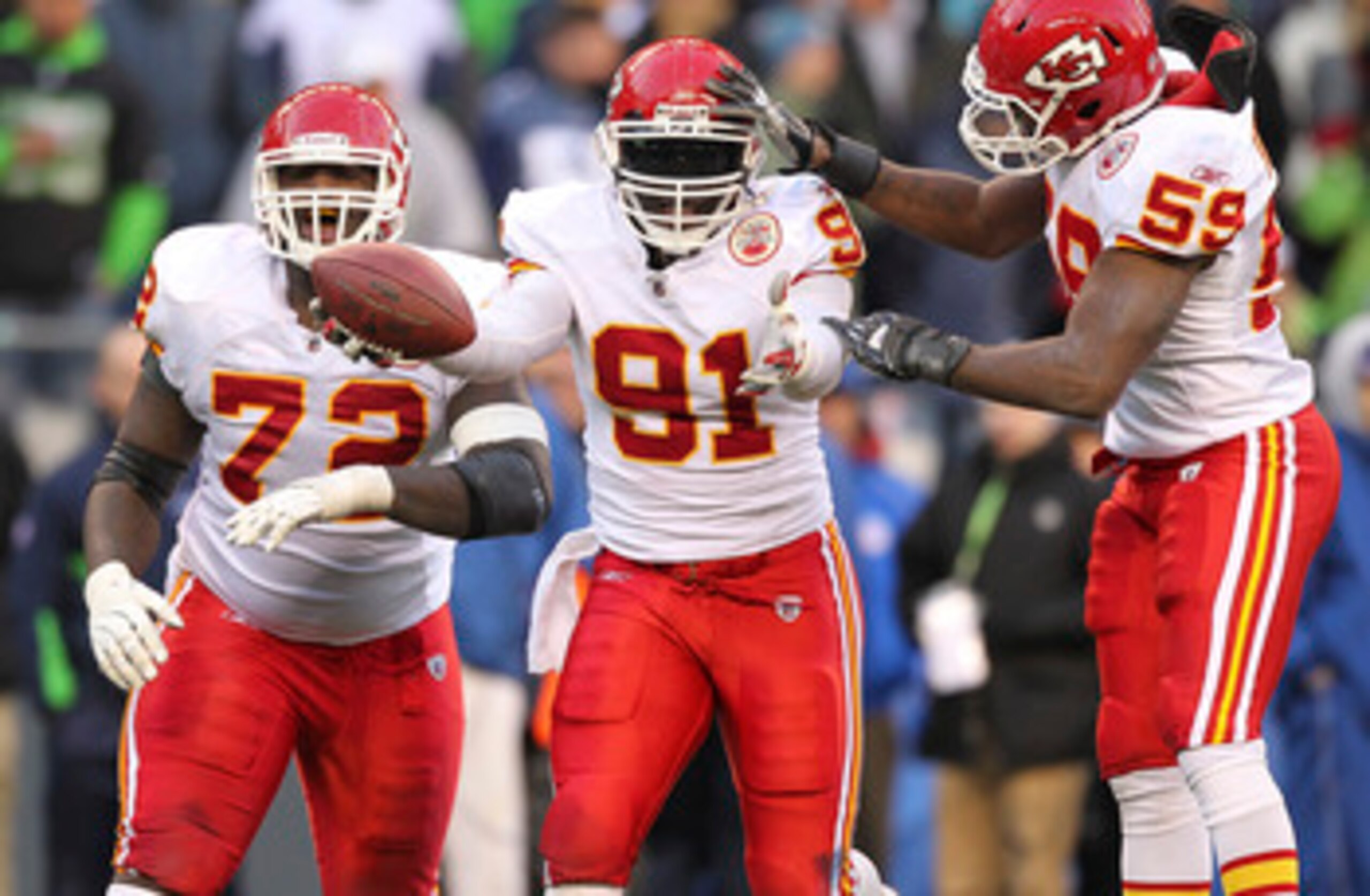 SEATTLE - NOVEMBER 28:  Linebacker Tamba Hali #91 of the Kansas City Chiefs celebrates with Glenn Dorsey #72 and Jovan Belcher #59 after recovering a fumble on a sack of quarterback Matt Hasselbeck of the Seattle Seahawks at Qwest Field on November 28, 20