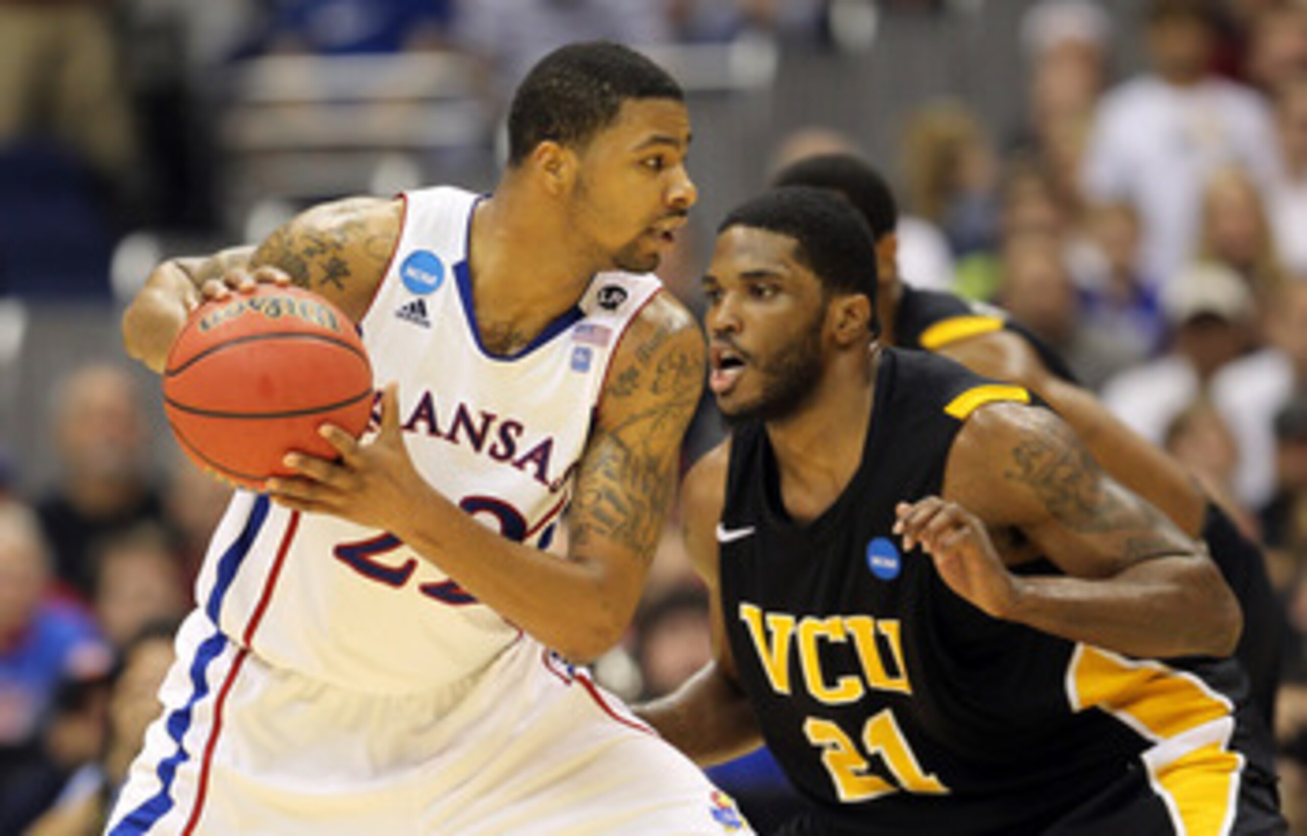 SAN ANTONIO, TX - MARCH 27:  Marcus Morris #22 of the Kansas Jayhawks handles the ball against Jamie Skeen #21 of the Virginia Commonwealth Rams during the southwest regional final of the 2011 NCAA men's basketball tournament at the Alamodome on March 27,