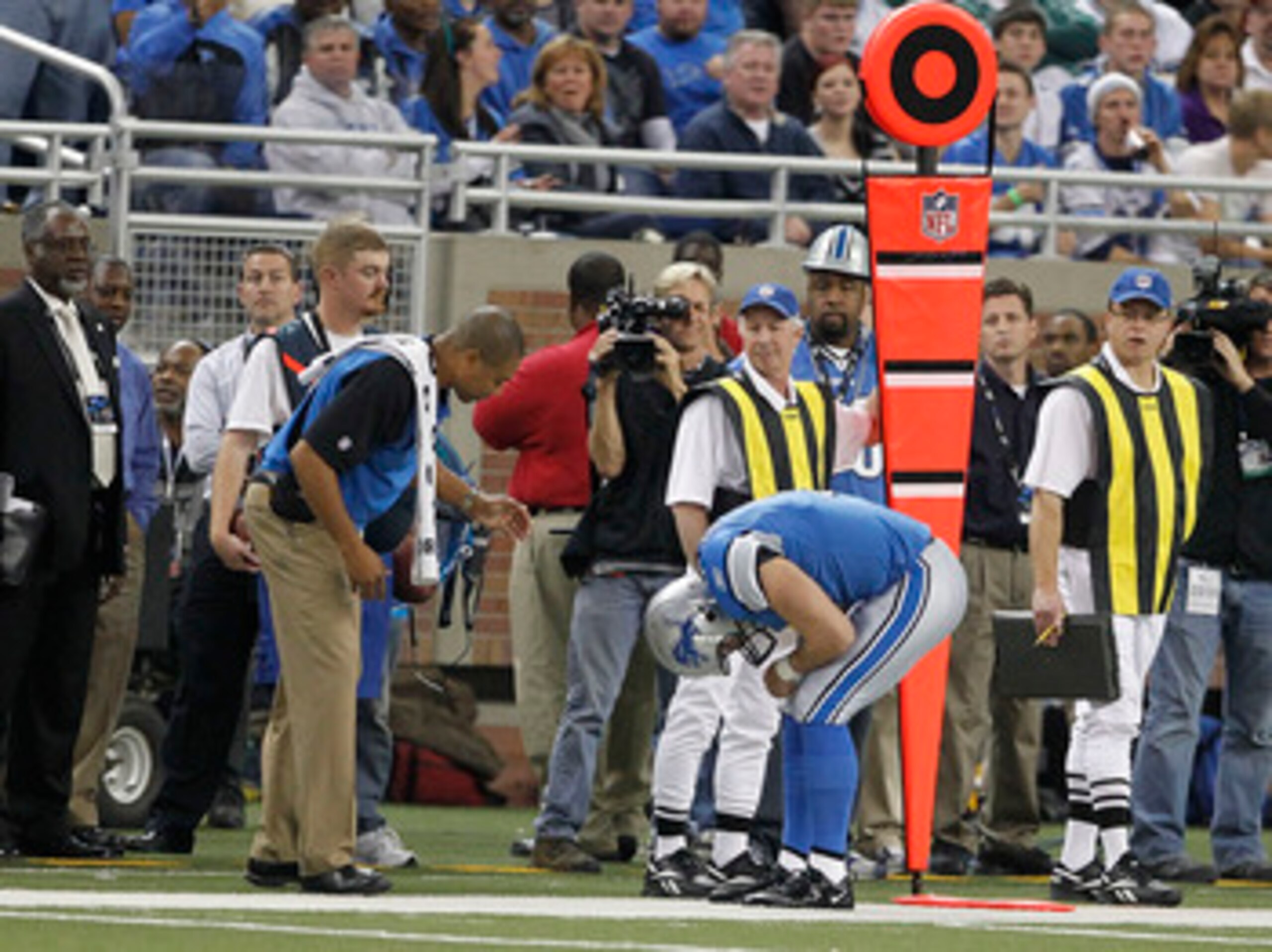 DETROIT - NOVEMBER 07:  Matthew Stafford #9 of the Detroit Lions bends over in pain against the New York Jets during the third quarter of the game at Ford Field on November 7, 2010 in Detroit, Michigan. The Jets defeated the Lions 23-20 in overtime.  (Pho