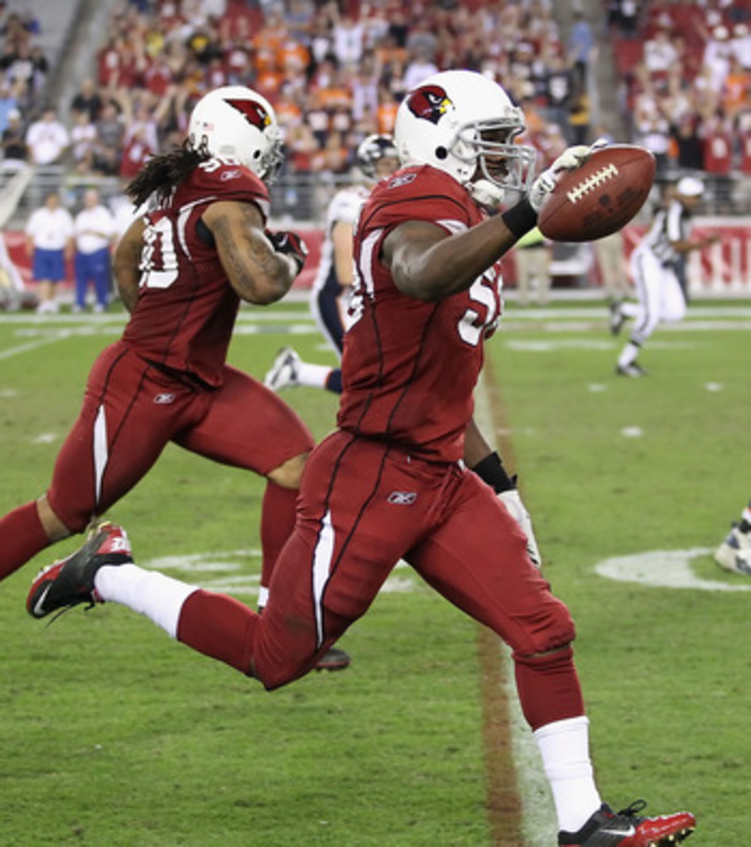 GLENDALE, AZ - DECEMBER 12:   Linebacker Daryl Washington #58 of the Arizona Cardinals runs with the football on a 40 touchdown interception against the Denver Broncos during the fourth quarter of the NFL game at the University of Phoenix Stadium on Decem