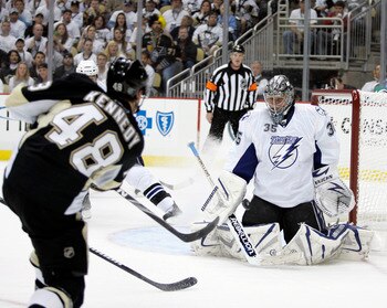 PITTSBURGH, PA - APRIL 23:  Dwayne Roloson #35 of the Tampa Bay Lightning makes a save on Tyler Kennedy #48 of the Pittsburgh Penguins in Game Five of the Eastern Conference Quarterfinals during the 2011 NHL Stanley Cup Playoffs at Consol Energy Center on