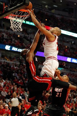 CHICAGO, IL - MAY 15:  Taj Gibson #22 of the Chicago Bulls dunks against Dwyane Wade #3 of the Miami Heat in Game One of the Eastern Conference Finals during the 2011 NBA Playoffs on May 15, 2011 at the United Center in Chicago, Illinois. NOTE TO USER: Us