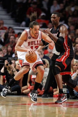 CHICAGO, IL - MAY 15:  Joakim Noah #13 of the Chicago Bulls posts up against Chris Bosh #1 of the Miami Heat in Game One of the Eastern Conference Finals during the 2011 NBA Playoffs on May 15, 2011 at the United Center in Chicago, Illinois. NOTE TO USER: