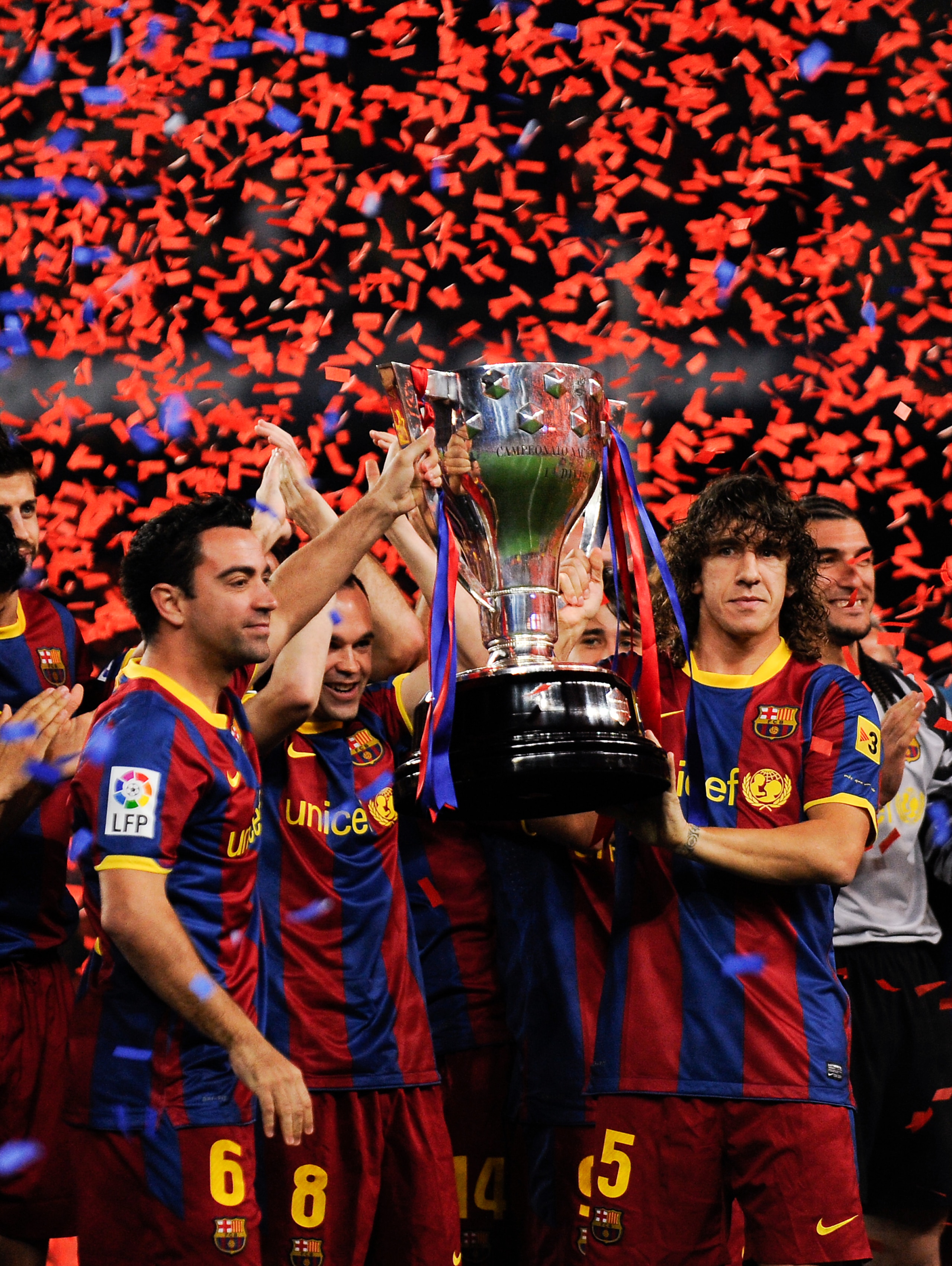 BARCELONA, SPAIN - MAY 15:  Xavi Hernandez and Carles Puyol of FC Barcelona hold aloft the La Liga trophy after the La Liga match between Barcelona and Deportivo La Coruna at Camp Nou Stadium on May 15, 2011 in Barcelona, Spain.  (Photo by David Ramos/Get