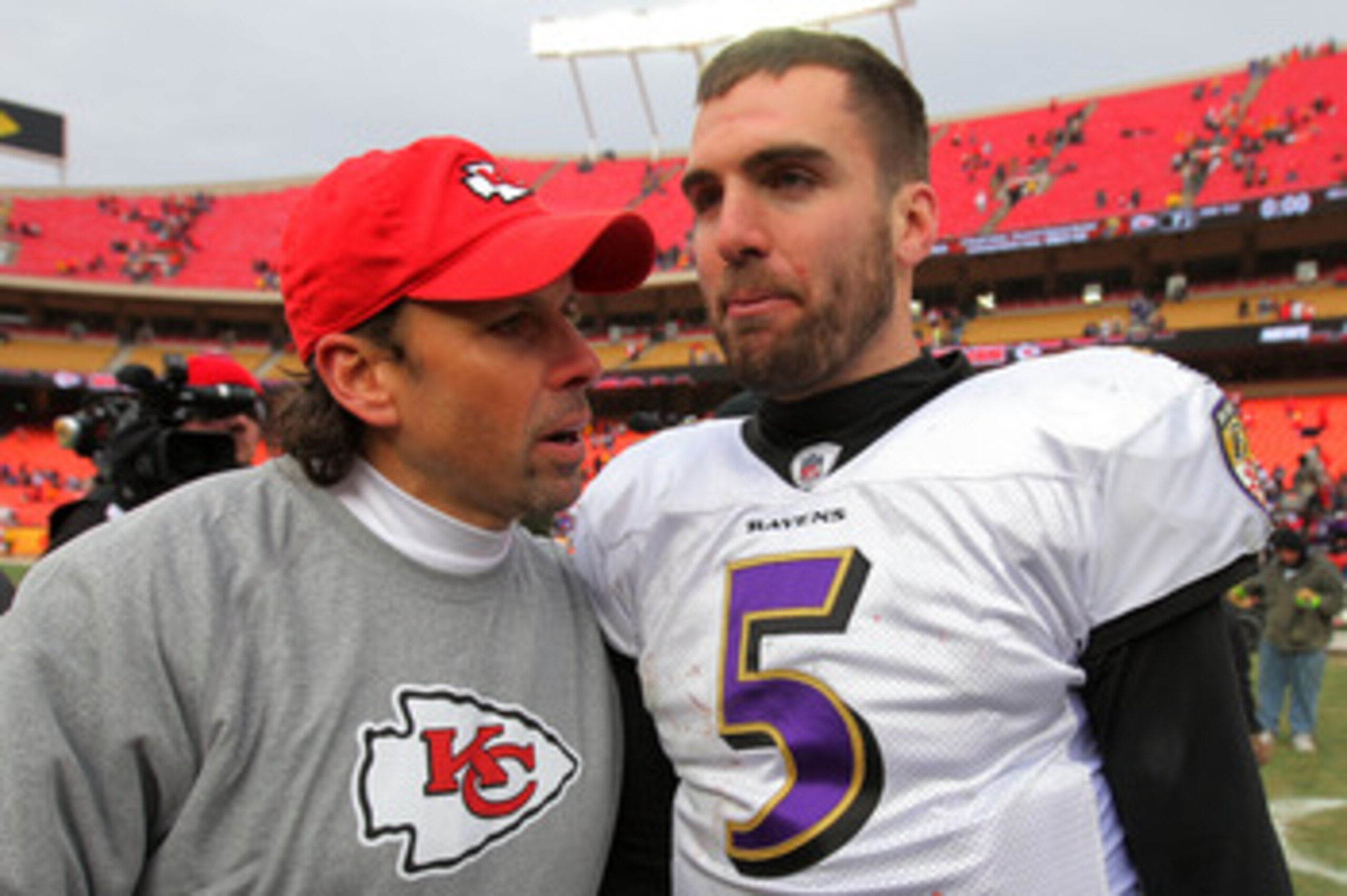 KANSAS CITY, MO - JANUARY 09:  Head coach Todd Haley of the Kansas City Chiefs and quarterback Joe Flacco #5 of the Baltimore Ravens speak to each other on the field after the Ravens defeated the Chiefs 30-7 in the 2011 AFC wild card playoff game at Arrow