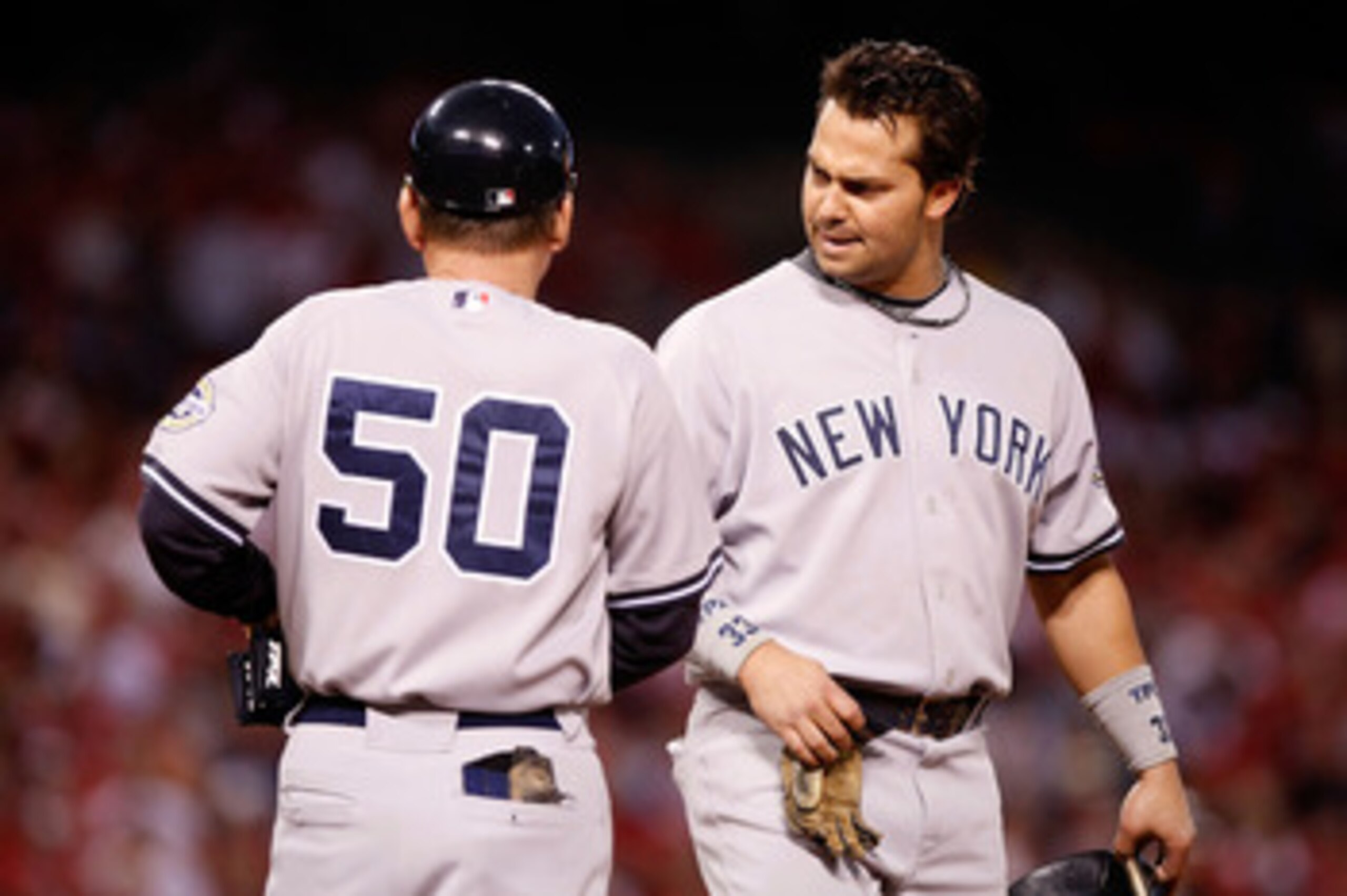 ANAHEIM, CA - OCTOBER 20:  Nick Swisher #33 (R) of the New York Yankees talks with first base coach Mick Kelleher in Game Four of the ALCS against the Los Angeles Angels of Anaheim during the 2009 MLB Playoffs at Angel Stadium on October 20, 2009 in Anahe