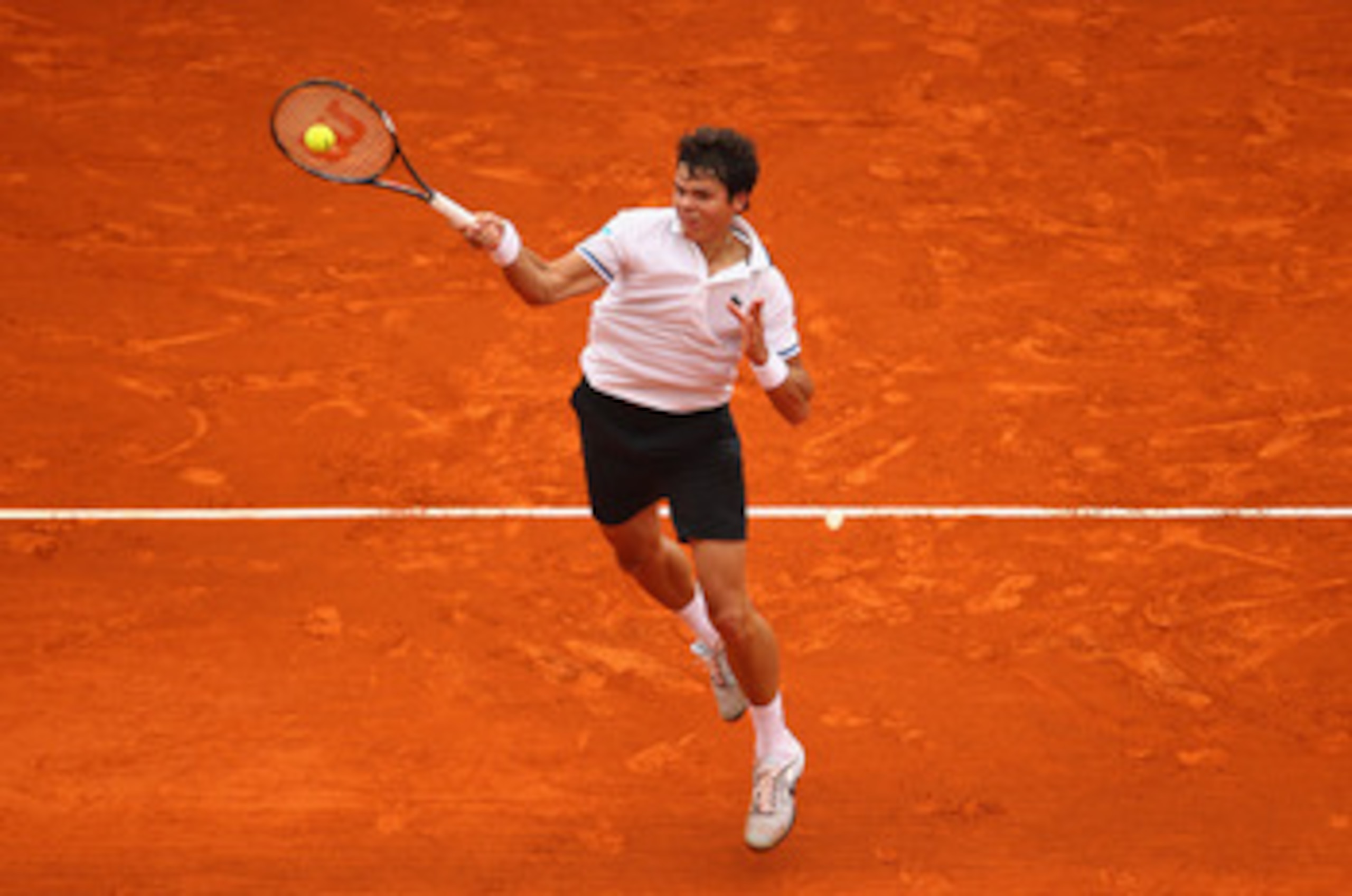 MONACO - APRIL 12:  Milos Raonic of Canada plays a forehand in his match against Ernests Gulbis of Latvia during Day Three of the ATP Masters Series Tennis at the Monte Carlo Country Club on April 12, 2011 in Monte Carlo, Monaco.  (Photo by Julian Finney/