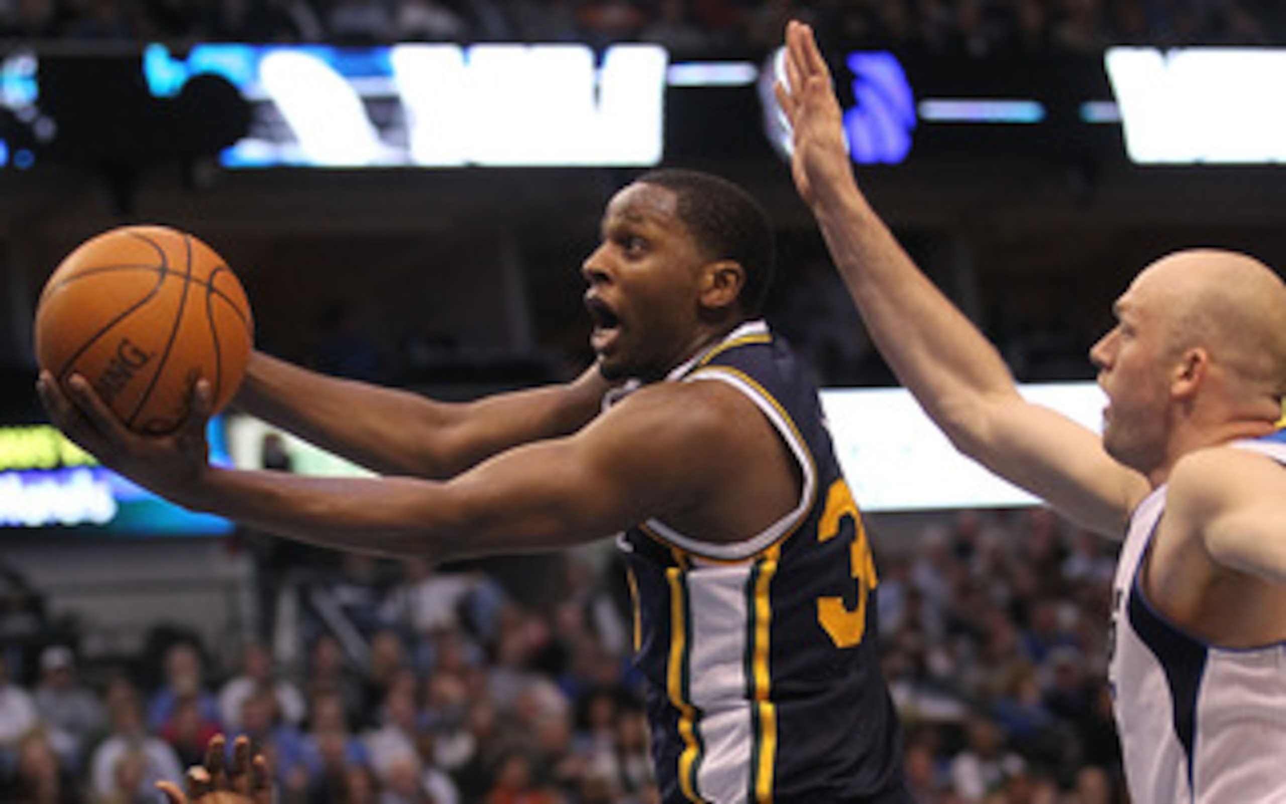 DALLAS, TX - FEBRUARY 23:  Forward C.J. Miles #34 of the Utah Jazz takes a shot against Brian Cardinal #35 of the Dallas Mavericks at American Airlines Center on February 23, 2011 in Dallas, Texas.  NOTE TO USER: User expressly acknowledges and agrees tha
