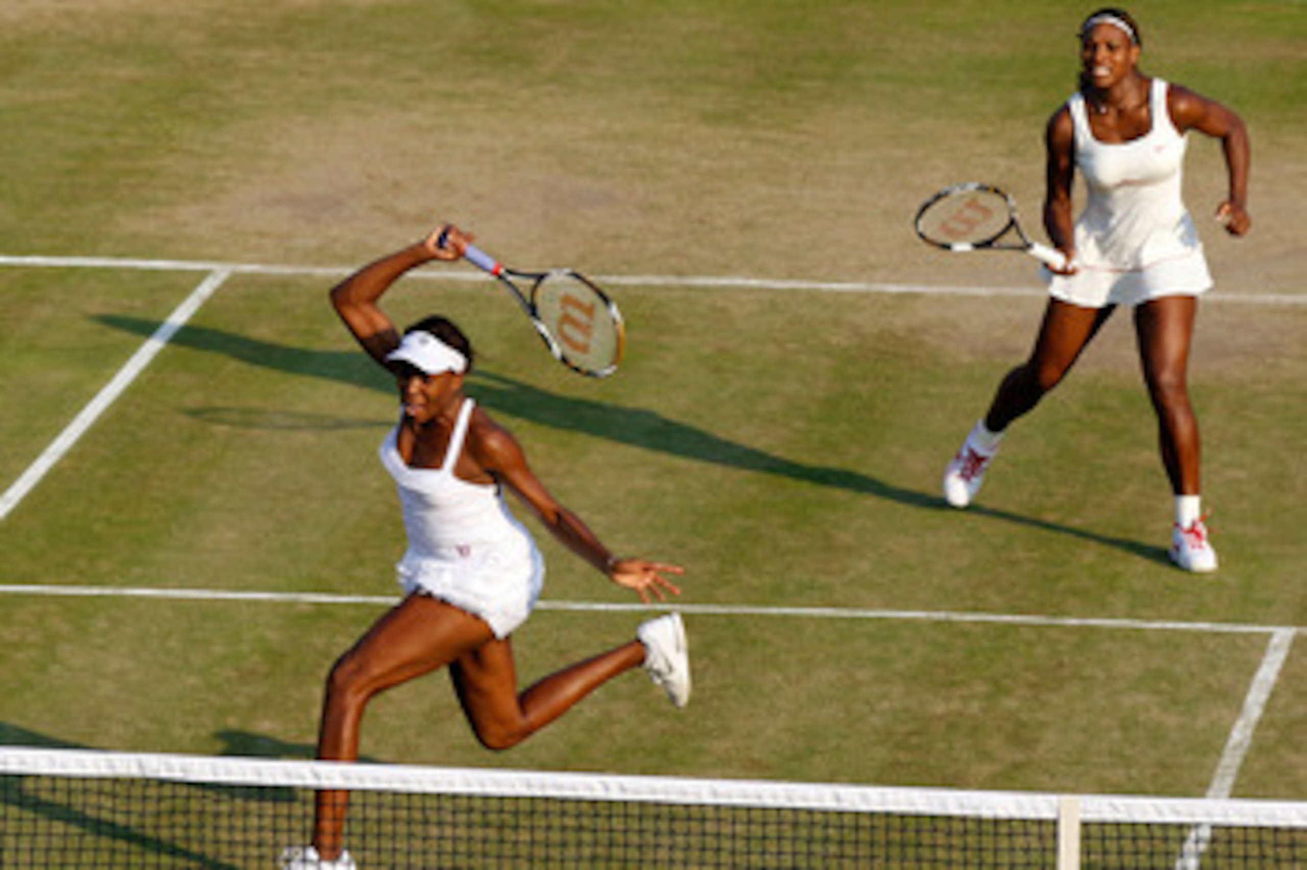LONDON, ENGLAND - JUNE 25:  Serena Williams of USA (R) and Venus Williams of USA in action during their doubles match against Dominika Cibulkova of Slovakia and Anastasia Pavlyuchenkova of Russia on Day Five of the Wimbledon Lawn Tennis Championships at t