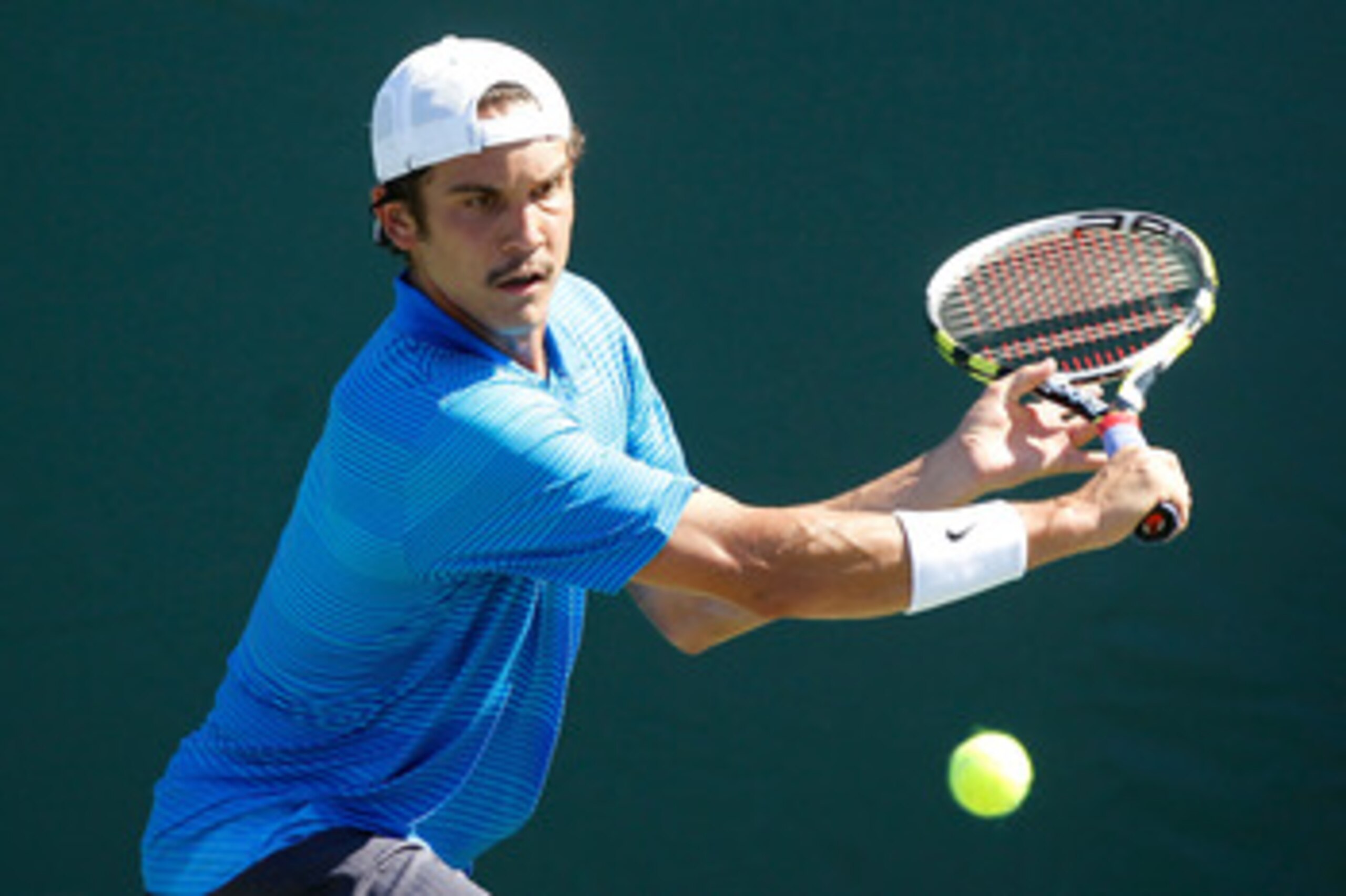KEY BISCAYNE, FL - MARCH 23:  Ryan Sweeting returns against Xavier Malisse of Belgium during the Sony Ericsson Open at Crandon Park Tennis Center on March 23, 2011 in Key Biscayne, Florida.  (Photo by Matthew Stockman/Getty Images)
