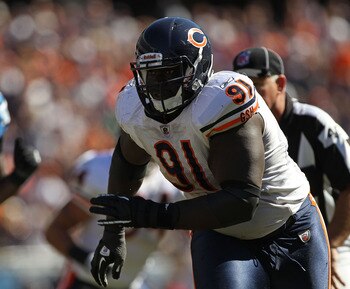 CHICAGO - SEPTEMBER 12: Tommie Harris #91 of the Chicago Bears pressures Shaun Hill of the Detroit Lions during the NFL season opening game at Soldier Field on September 12, 2010 in Chicago, Illinois. The Bears defeated the Lions 19-14. (Photo by Jonathan