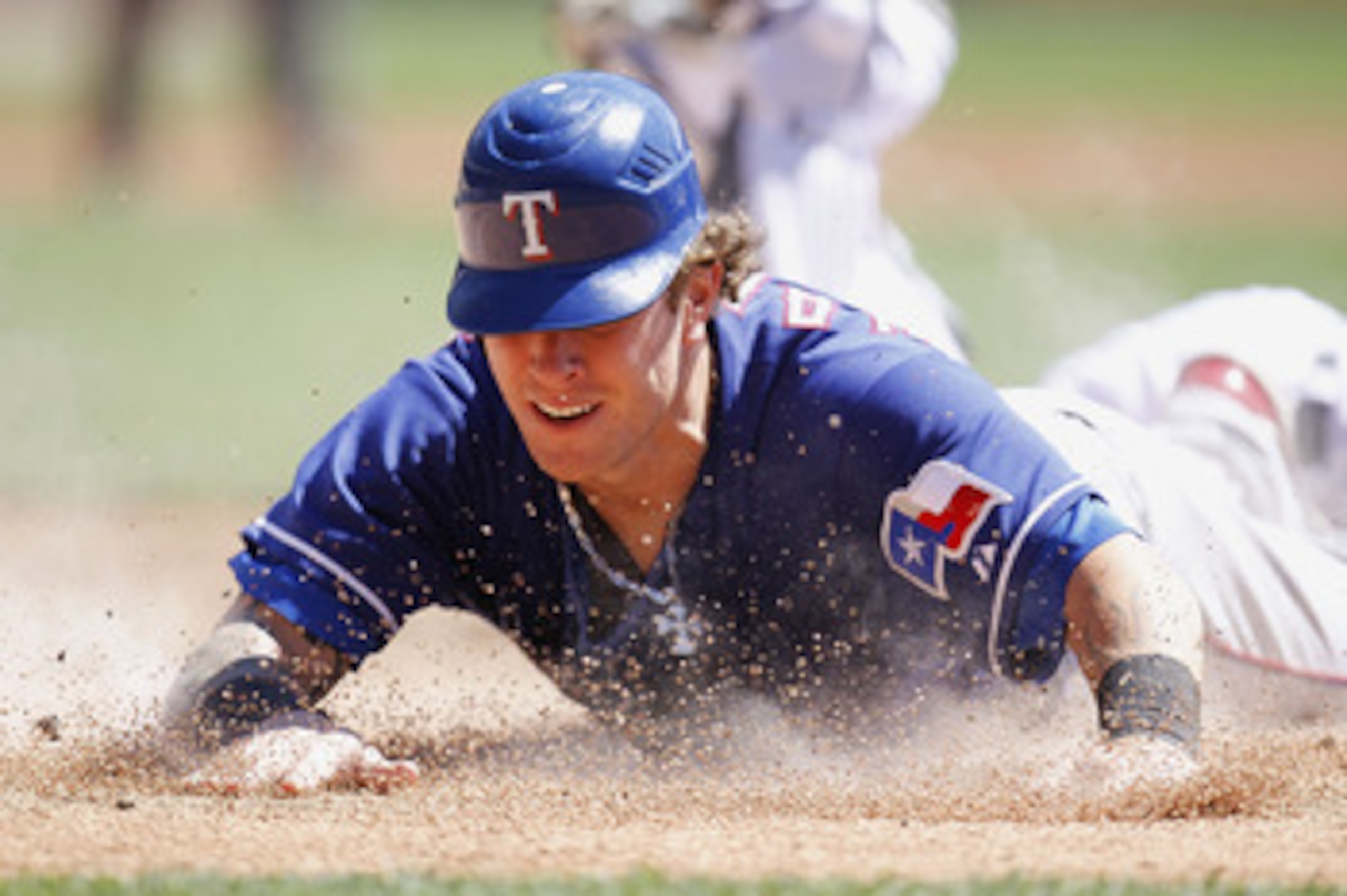 DETROIT, MI - APRIL 12:  Josh Hamilton #32 of the Texas Rangers slides into home plate during the third inning while playing the Detroit Tigers at Comerica Park on April 12, 2011 in Detroit, Michigan. Hamilton was out from a tag by Victor Martinez  (Photo
