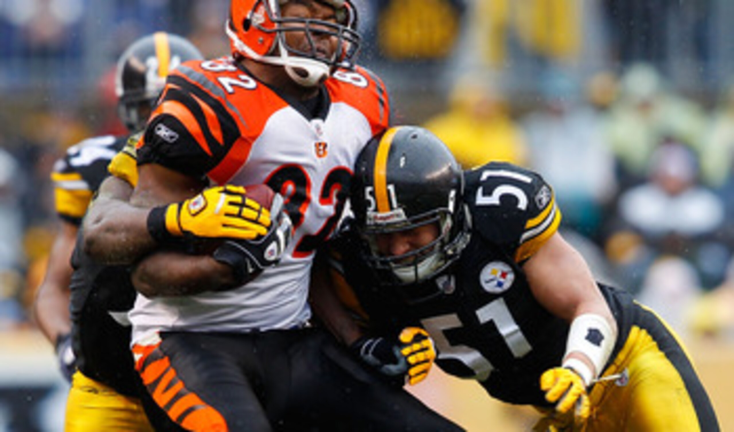 PITTSBURGH - DECEMBER 12:  Reggie Kelly #82 of the Cincinnati Bengals is hit by James Farrior #51 of the Pittsburgh Steelers after catching a pass during the game on December 12, 2010 at Heinz Field in Pittsburgh, Pennsylvania.  (Photo by Jared Wickerham/