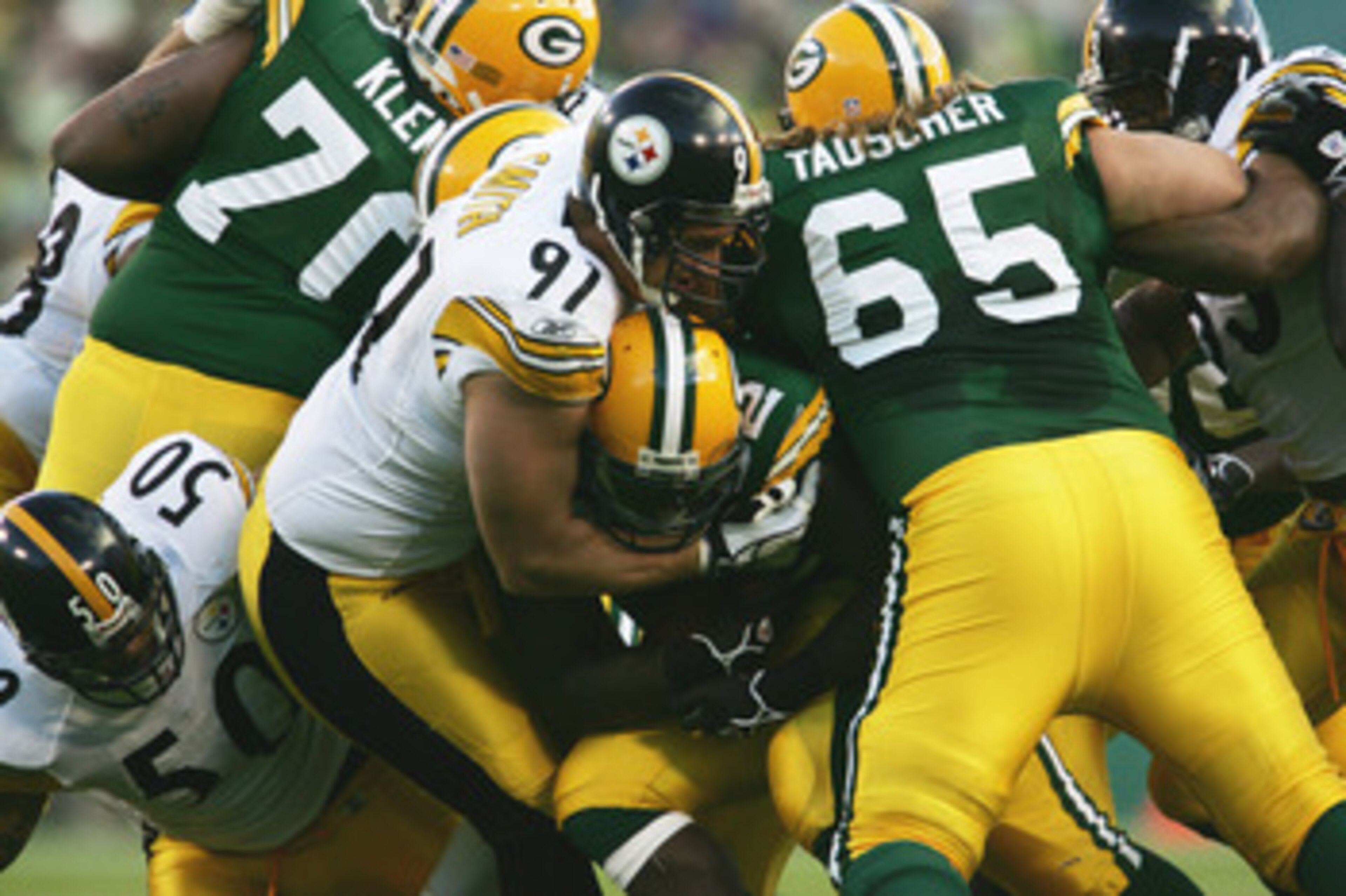 GREEN BAY, WI - NOVEMBER 6:  Defensive end Aaron Smith #91 of the Pittsburgh Steelers tackles running back ReShard Lee #32 of the Green Bay Packers at Lambeau Field on November 6, 2005 in Green Bay, Wisconsin. The Steelers defeated the Packers 20-10.  (Ph