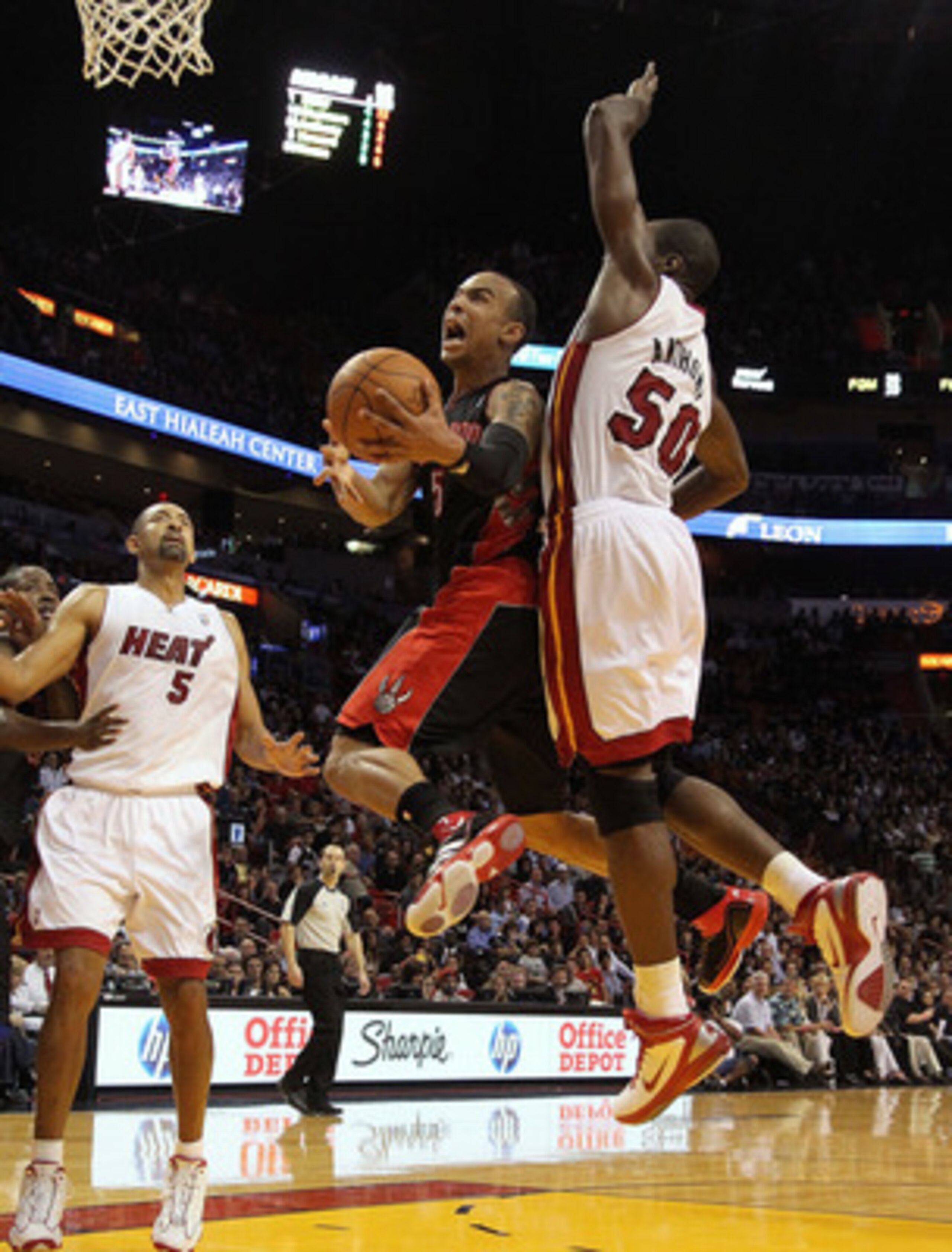 MIAMI, FL - JANUARY 22:  Jerryd Bayless #5 of the Toronto Raptors goes up for a shot against Joel Anthony #50 of the Miami Heat during a game at American Airlines Arena on January 22, 2011 in Miami, Florida. NOTE TO USER: User expressly acknowledges and a