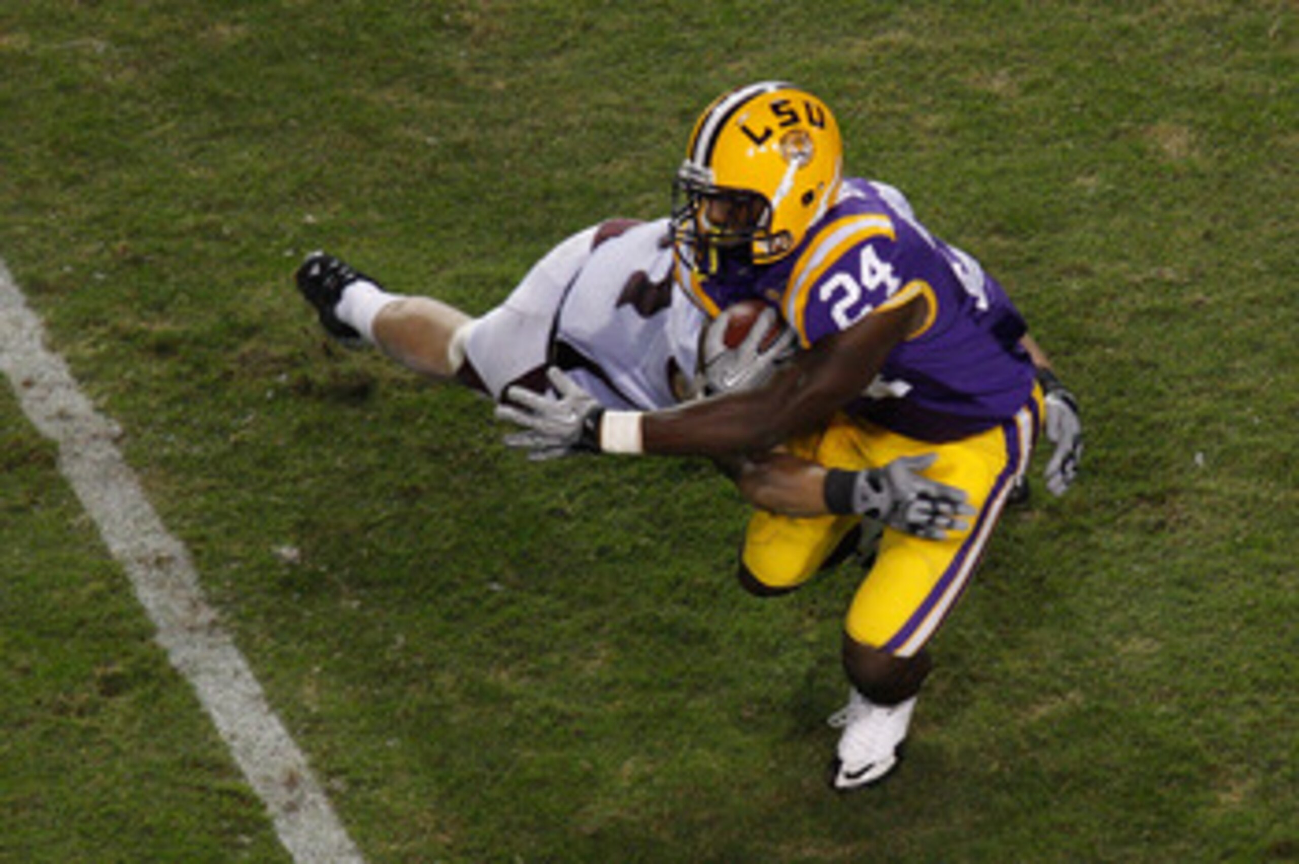 BATON ROUGE, LA - NOVEMBER 13:  Alfred Blue #24 of the Louisiana State University Tigers is tackled by Ty Kittle #87 of the University of Louisiana-Monroe Warhawks at Tiger Stadium on November 13, 2010 in Baton Rouge, Louisiana.   The Tigers defeated the 