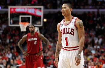 CHICAGO, IL - MAY 18:  Derrick Rose #1 of the Chicago Bulls looks on as LeBron James #6 of the Miami Heat stands in the background in Game Two of the Eastern Conference Finals during the 2011 NBA Playoffs on May 18, 2011 at the United Center in Chicago, I