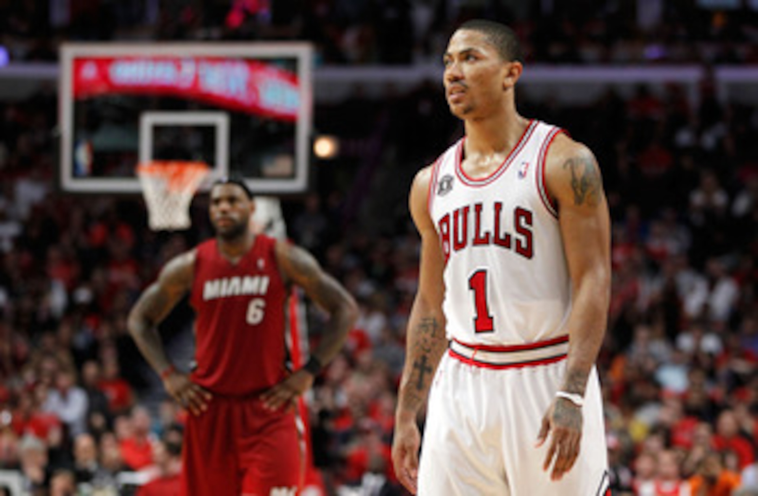 CHICAGO, IL - MAY 18:  Derrick Rose #1 of the Chicago Bulls looks on as LeBron James #6 of the Miami Heat stands in the background in Game Two of the Eastern Conference Finals during the 2011 NBA Playoffs on May 18, 2011 at the United Center in Chicago, I