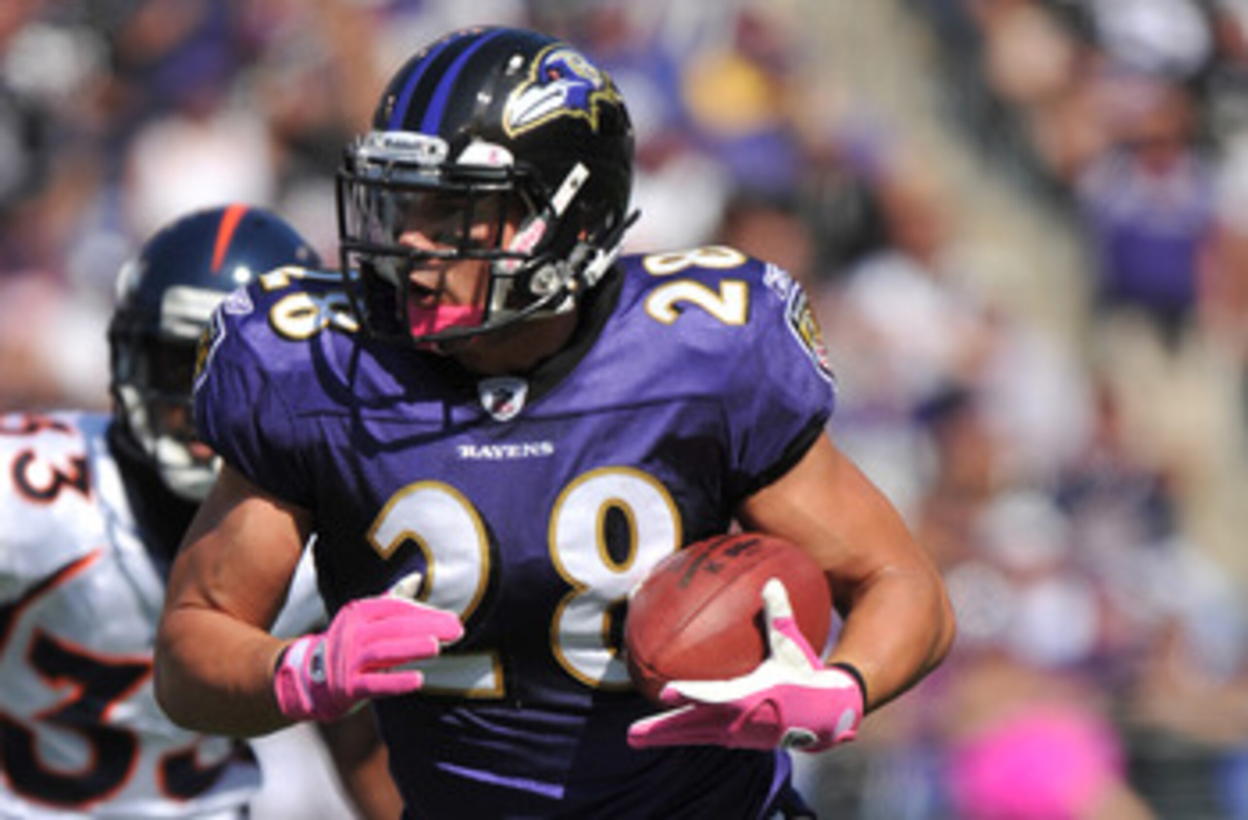BALTIMORE, MD - OCTOBER 10: Tom Zbikowski #28 of the Baltimore Ravens runs the ball against the Denver Broncos at M&T Bank Stadium on October 10, 2010 in Baltimore, Maryland. Players wore pink in recognition of Breast Cancer Awareness Month. The Ravens de