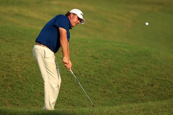 PONTE VEDRA BEACH, FL - MAY 14:  Phil Mickelson hits an approach shot on the ninth hole during the third round of THE PLAYERS Championship held at THE PLAYERS Stadium course at TPC Sawgrass on May 14, 2011 in Ponte Vedra Beach, Florida.  (Photo by Streete