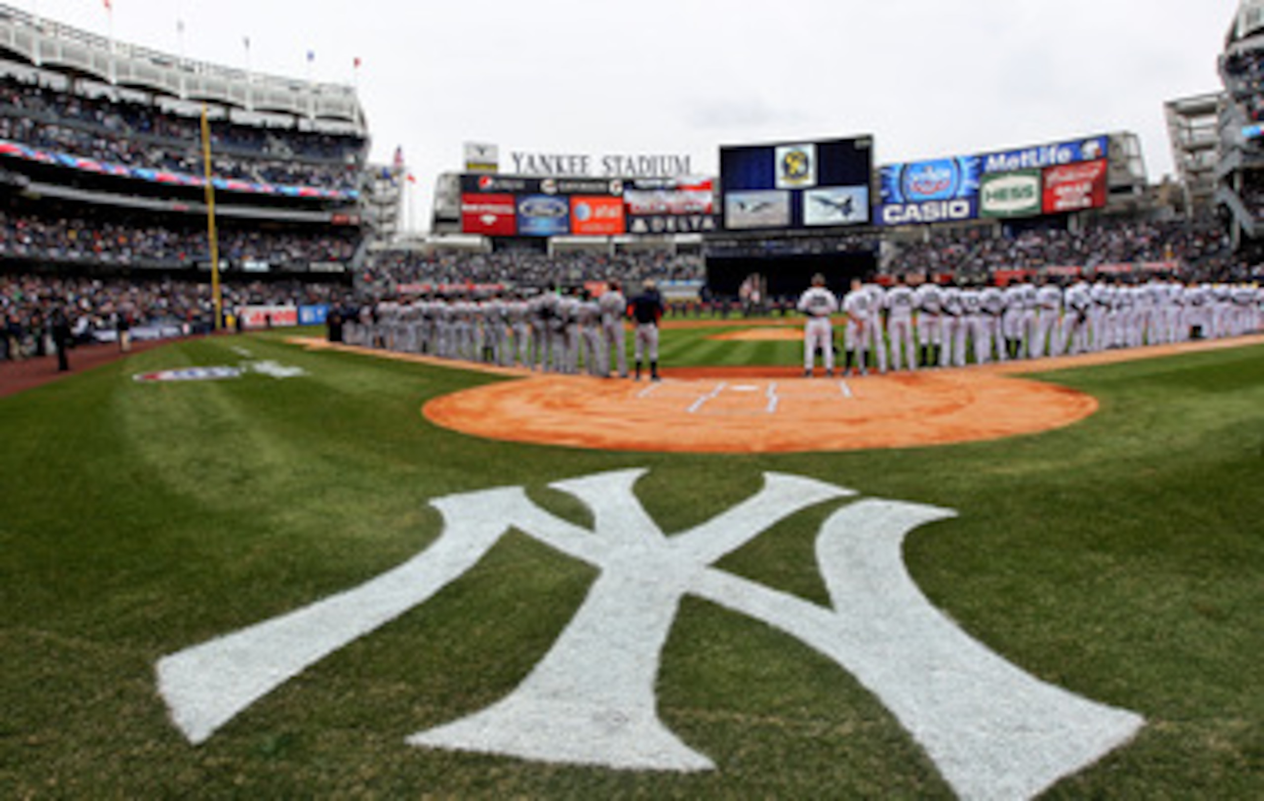NEW YORK, NY - MARCH 31:  The New York Yankees and the Detroit Tigers look on as West Point Cadets unfurl the American Flag during the opening ceremonies on Opening Day at Yankee Stadium on March 31, 2011 in Bronx borough of New York City.  (Photo by Nick