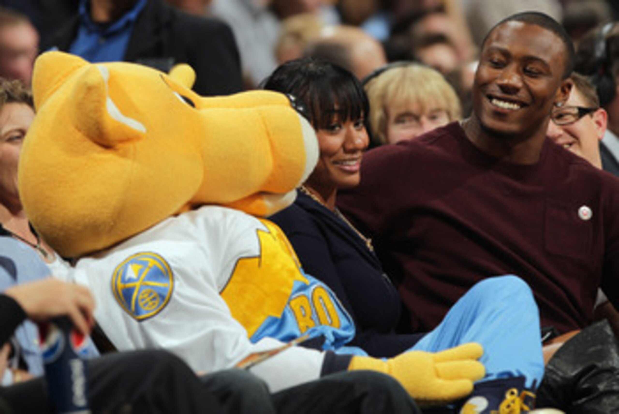 DENVER, CO - FEBRUARY 10:  Rocky (L), the mascot of the Denver Nuggets interacts with Brandon Marshall (R), wide receiver for the Miami Dolphins and his companion (C) as they sit courtside as the Nuggets face the Dallas Mavericks during NBA action at the 