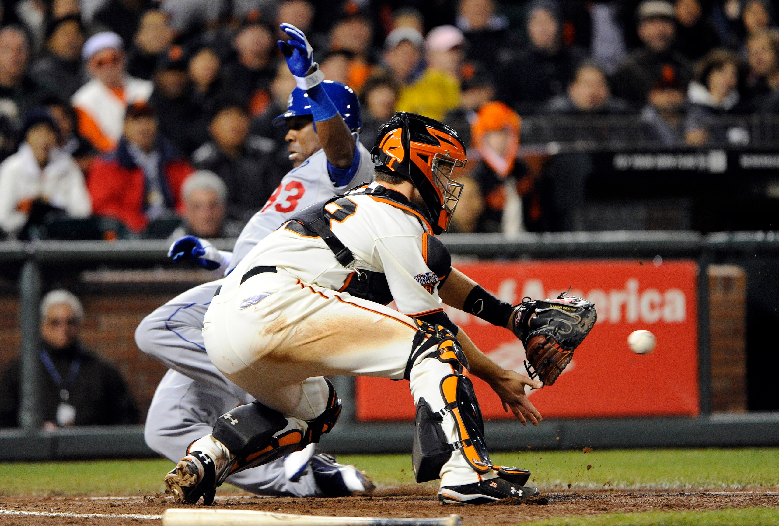 SAN FRANCISCO, CA - APRIL 13: Marcus Thames #33 of the Los Angeles Dodgers slides safely at home plate, beating the throw to Buster Posey #28 of the San Francisco Giants during a MLB baseball game at AT&T Park April 13, 2011 in San Francisco, California.