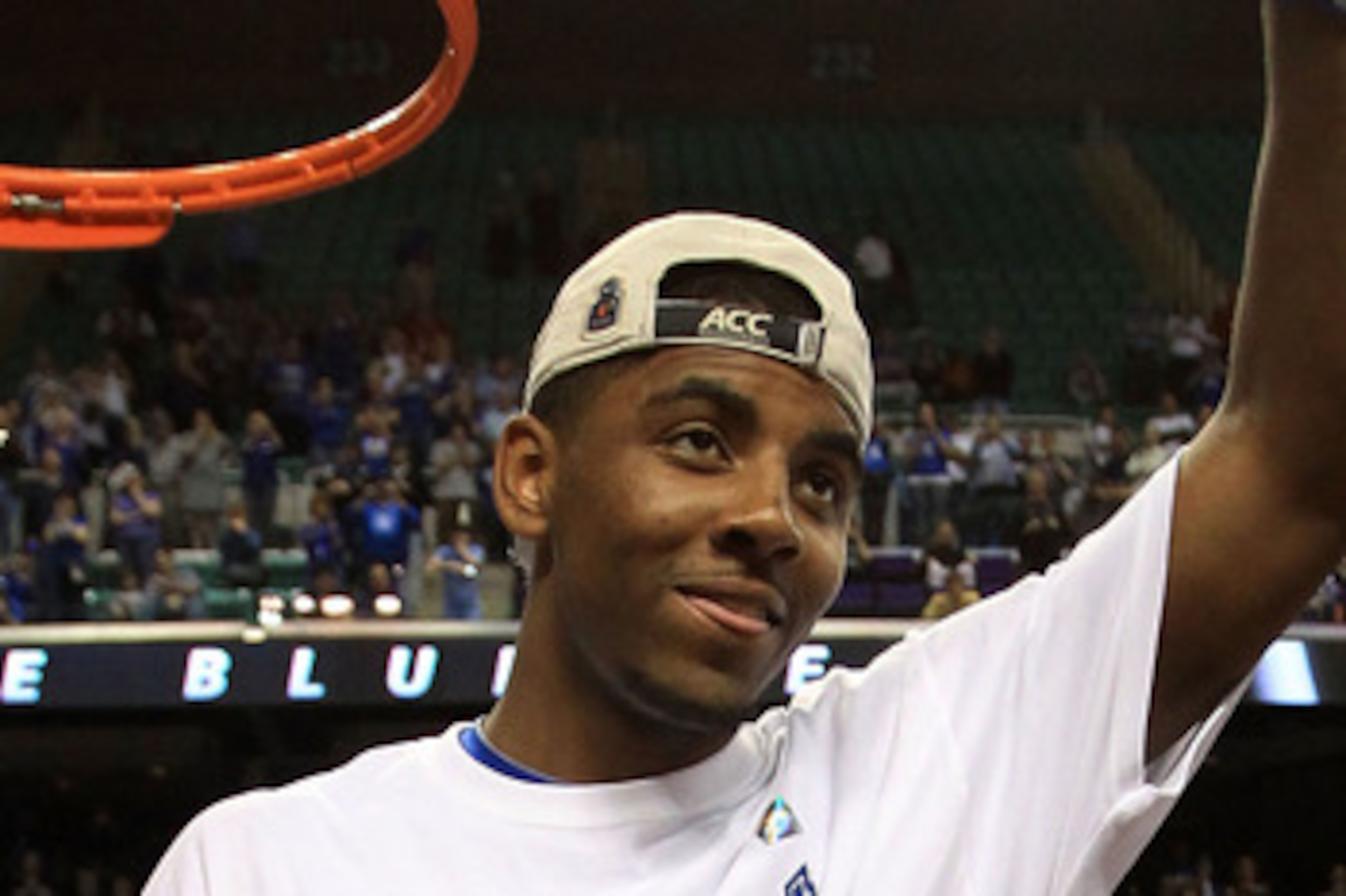 GREENSBORO, NC - MARCH 13:  Kyrie Irving #1 of the Duke Blue Devils cuts down the net after defeating the North Carolina Tar Heels 75-58 in the championship game of the 2011 ACC men's basketball tournament at the Greensboro Coliseum on March 13, 2011 in G