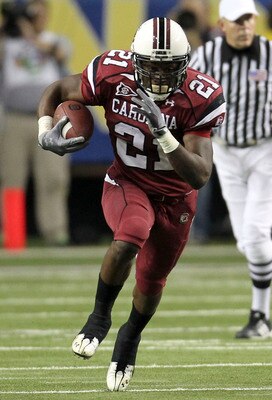 ATLANTA - DECEMBER 4:  Running back Marcus Lattimore #21 of the South Carolina Gamecocks runs with the ball during the 2010 SEC Championship against the Auburn Tigers at Georgia Dome on December 4, 2010 in Atlanta, Georgia. (Photo by Mike Zarrilli/Getty I