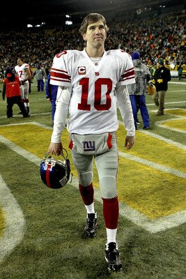 GREEN BAY, WI - DECEMBER 26: Eli Manning #10 of the New York Giants walks off the field after loosing to the Green Bay Packers at Lambeau Field on December 26, 2010 in Green Bay, Wisconsin.  (Photo by Matthew Stockman/Getty Images)