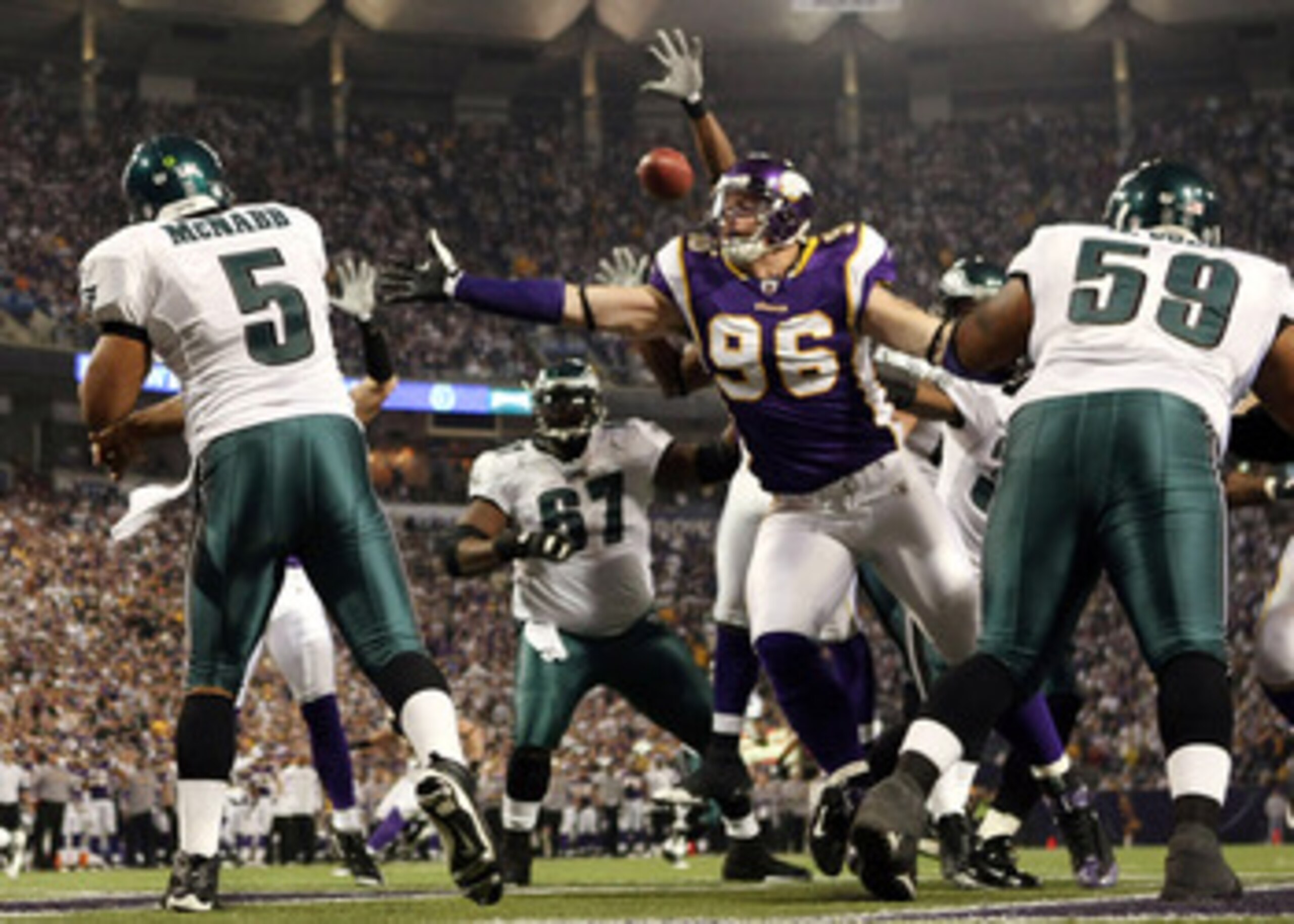 MINNEAPOLIS - JANUARY 04:   Donovan McNabb #5 of the Philadelphia Eagles passes the ball under pressure from Brian Robison #96 of the Minnesota Vikings during the NFC Wild Card playoff game on January 4, 2009 at the Hubert H. Humphrey Metrodome in Minneap