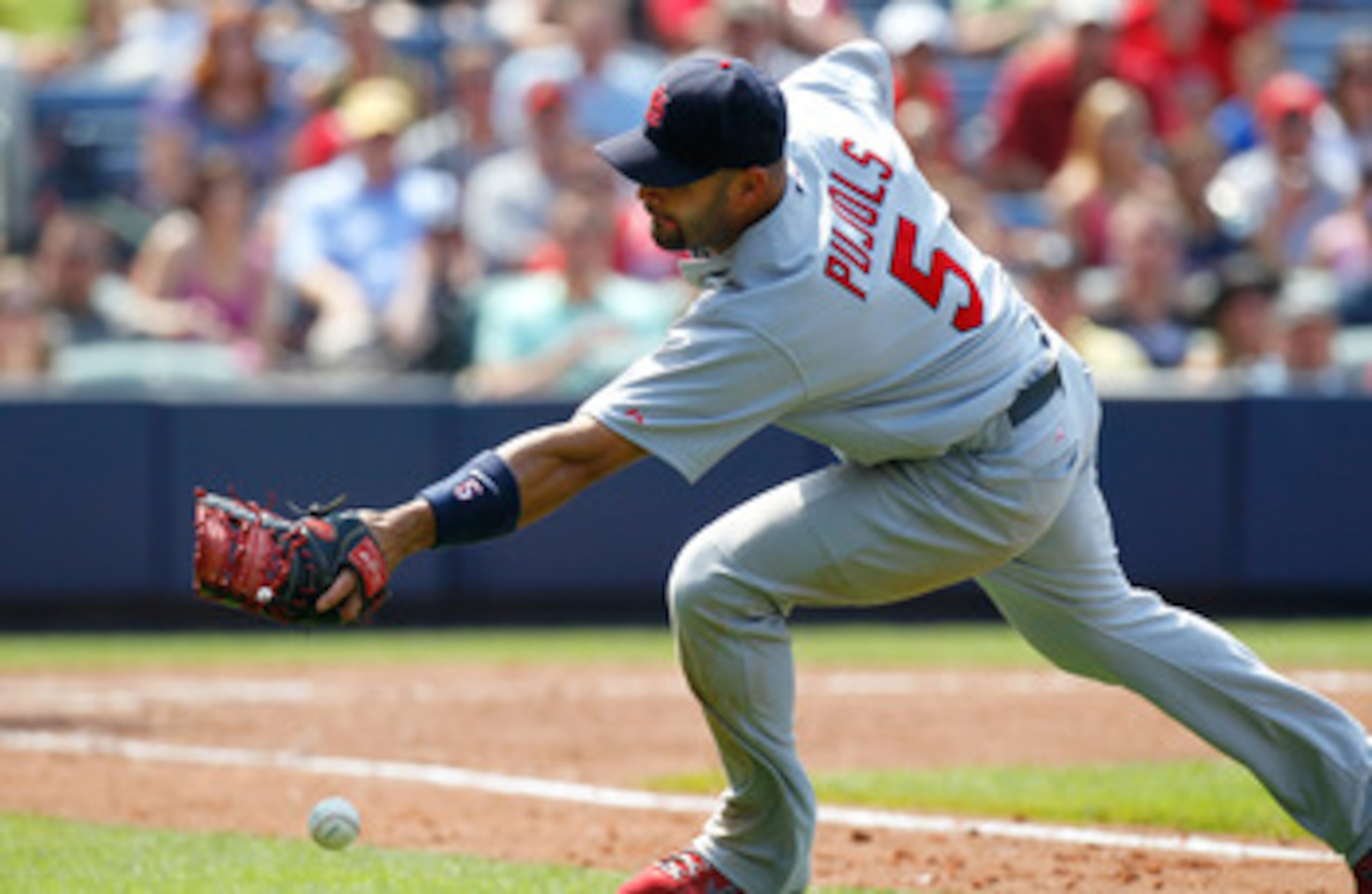 ATLANTA, GA - MAY 01:  Albert Pujols #5 of the St. Louis Cardinals chases after a bunted foul ball hit by Alex Gonzalez #2 of the Atlanta Braves in the seventh inning at Turner Field on May 1, 2011 in Atlanta, Georgia.  (Photo by Kevin C. Cox/Getty Images