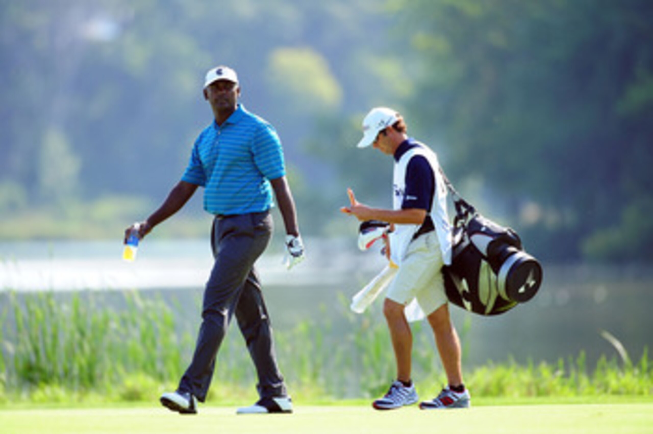 CHASKA, MN - AUGUST 14:  Vijay Singh of Fiji walks with his caddie Chad Reynolds on the 16th hole during the second round of the 91st PGA Championship at Hazeltine National Golf Club on August 14, 2009 in Chaska, Minnesota.  (Photo by Stuart Franklin/Gett