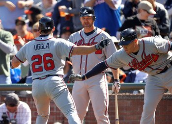 SAN FRANCISCO, CA - APRIL 24:  Dan Uggla #26 of the Atlanta Braves is congratulated by Freddie Freeman #5 and David Ross #8 after he hits a a home run to tie the game 6-6 in the eighth inning at AT&T Park on April 24, 2011 in San Francisco, California.  (