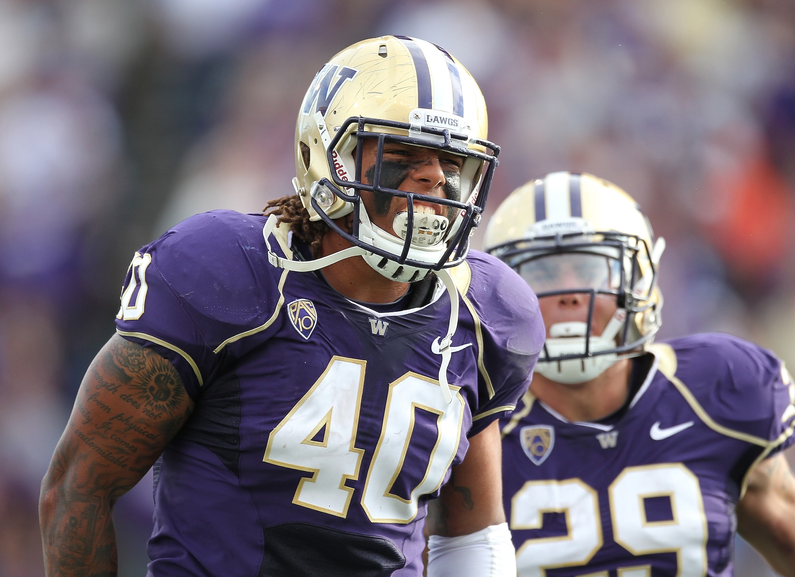 SEATTLE - SEPTEMBER 11: Linebacker Mason Foster #40 of the Washington Huskies celebrates with Willis Wilson #29 after tackling quarterback Ryan Nassib #12 of the Syracuse Orange and causing a fumble on September 11, 2010 at Husky Stadium in Seattle, Wash SEATTLE - SEPTEMBER 11: Linebacker Mason Foster #40 of the Washington Huskies celebrates with Willis Wilson #29 after tackling quarterback Ryan Nassib #12 of the Syracuse Orange and causing a fumble on September 11, 2010 at Husky Stadium in Seattle, Wash
