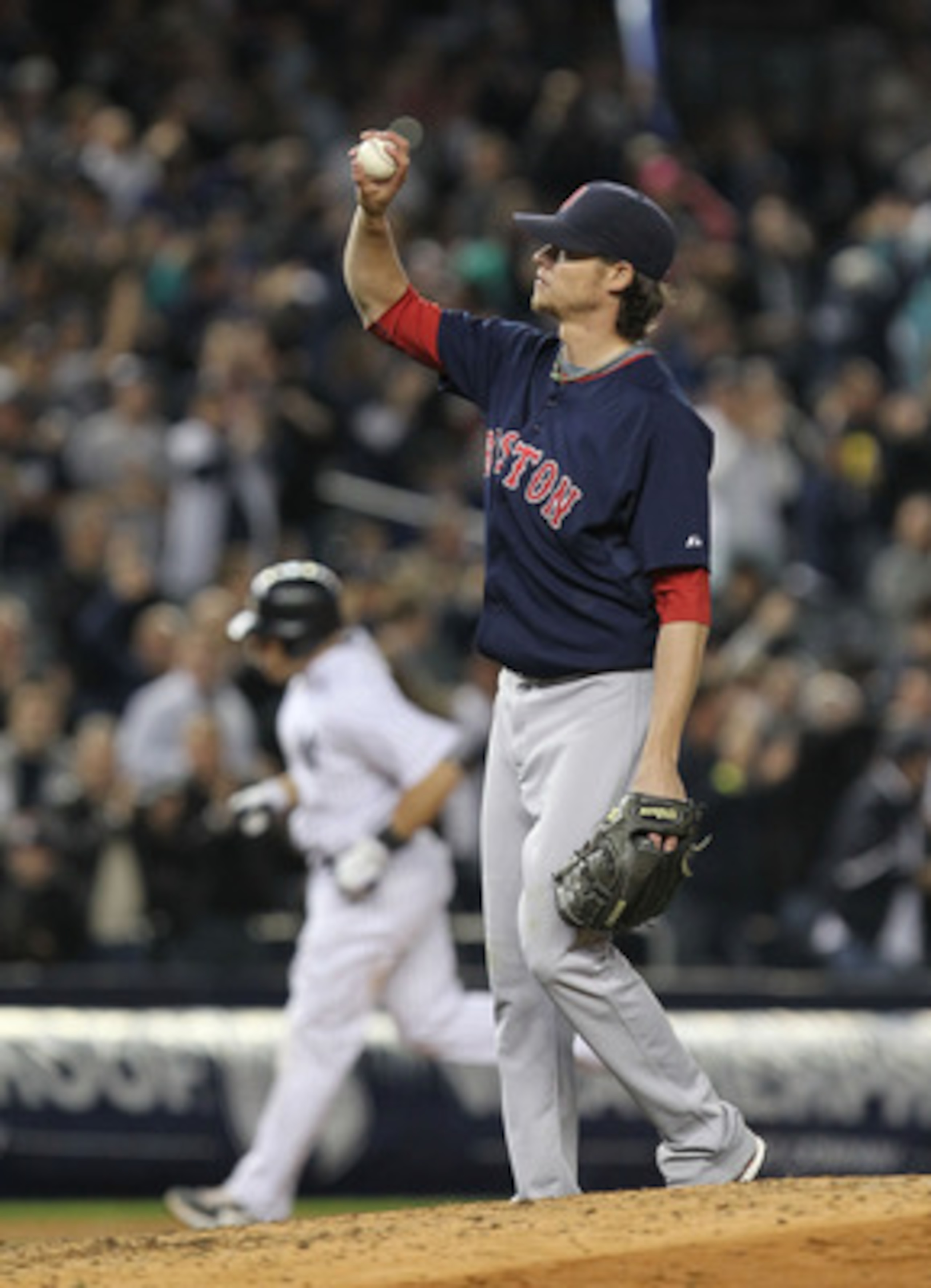 NEW YORK, NY - MAY 13: Clay Buchholz #11 of the Boston Red Sox reacts after giving up a home run to Russell Martin #55 of the New York Yankees who is rounding the bases during their game on May 13, 2011 at Yankee Stadium in the Bronx borough of New York C