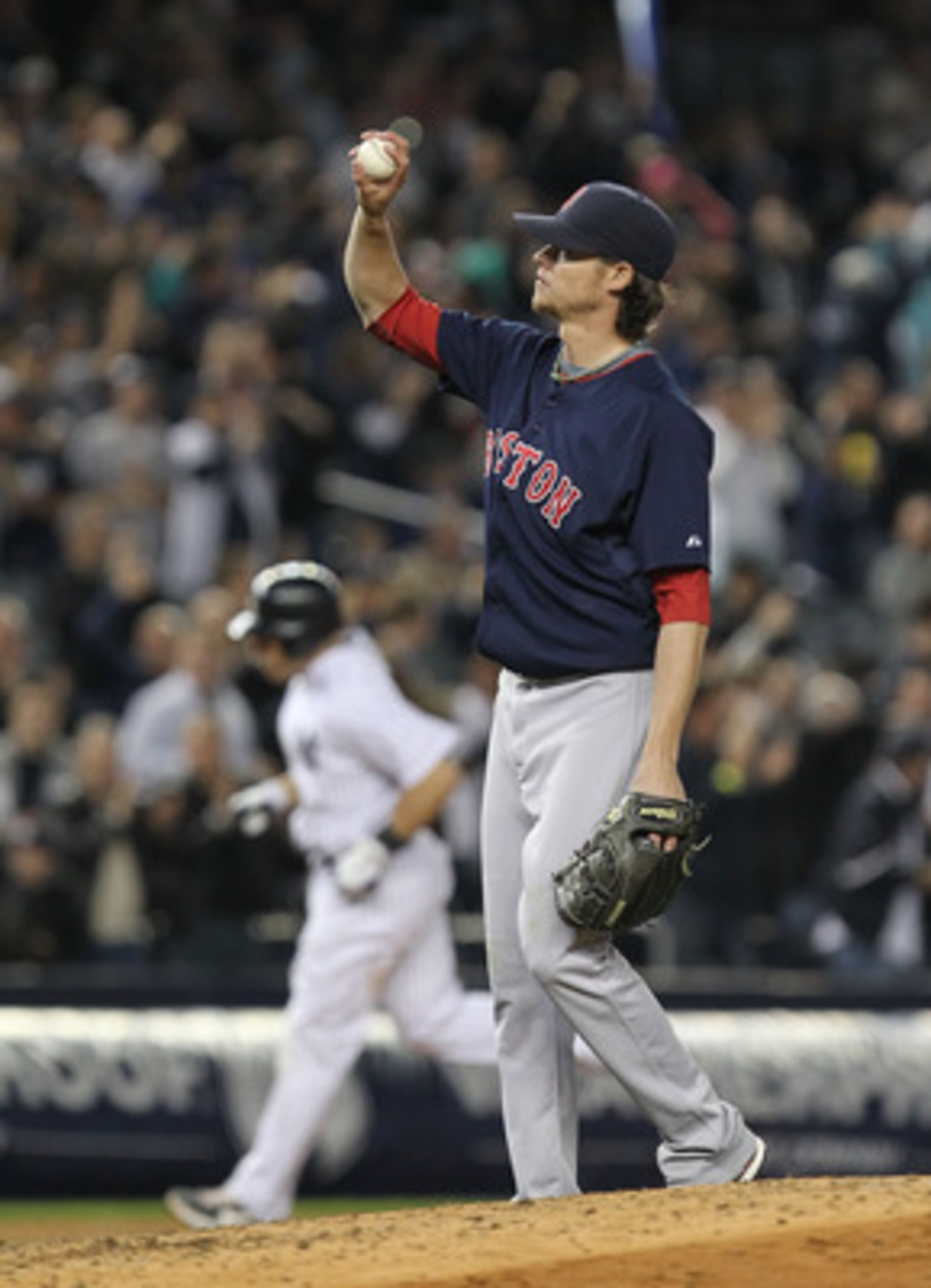 NEW YORK, NY - MAY 13: Clay Buchholz #11 of the Boston Red Sox reacts after giving up a home run to Russell Martin #55 of the New York Yankees who is rounding the bases during their game on May 13, 2011 at Yankee Stadium in the Bronx borough of New York C