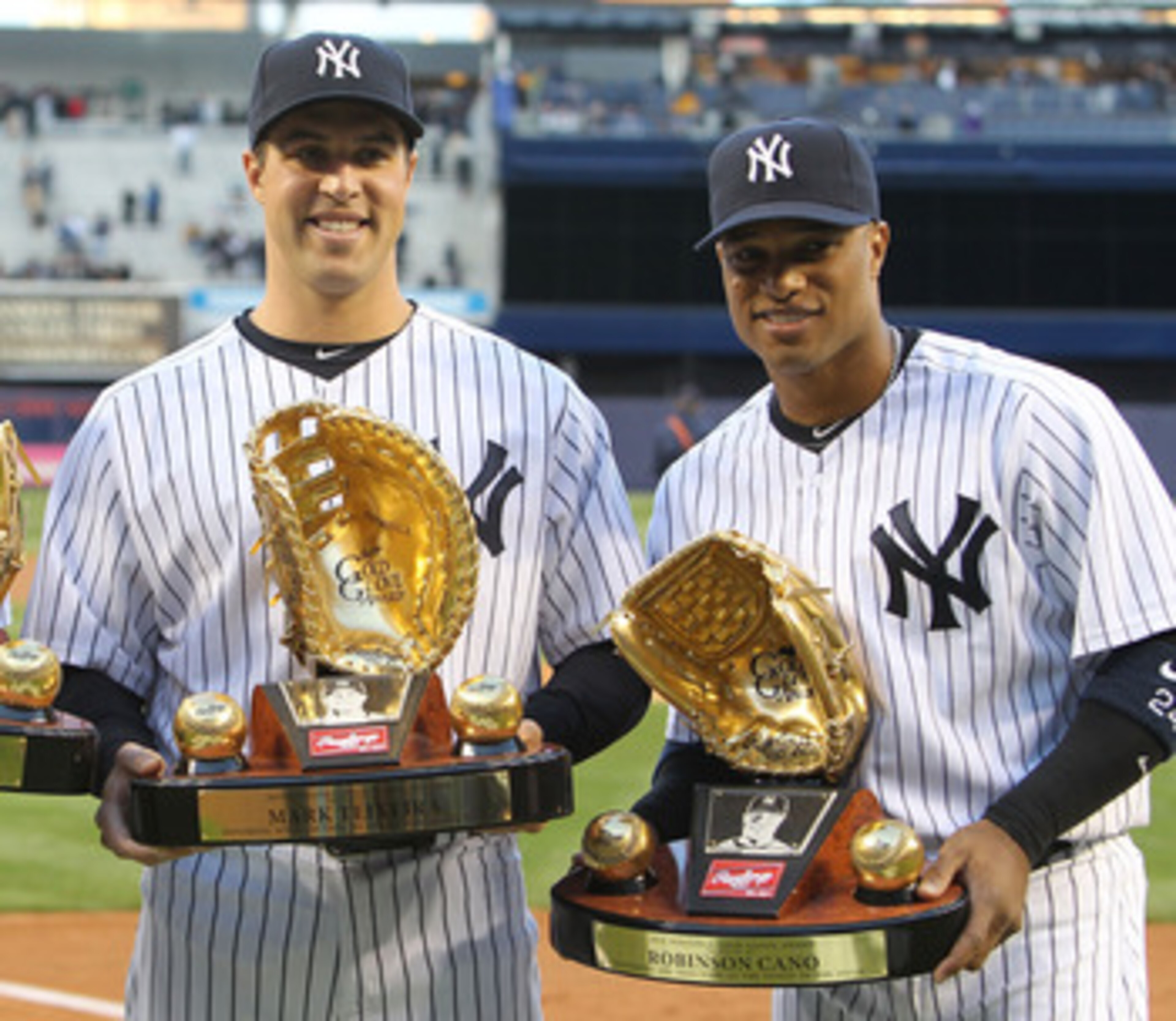 NEW YORK, NY - APRIL 05: (L-R) Derek Jeter #2, Mark Teixeira #25 and Robinson Cano #24 of the New York Yankees pose with their Gold Glove Awards prior to their game against the Minnesota Twins at Yankee Stadium on April 5, 2011 in the Bronx borough of New
