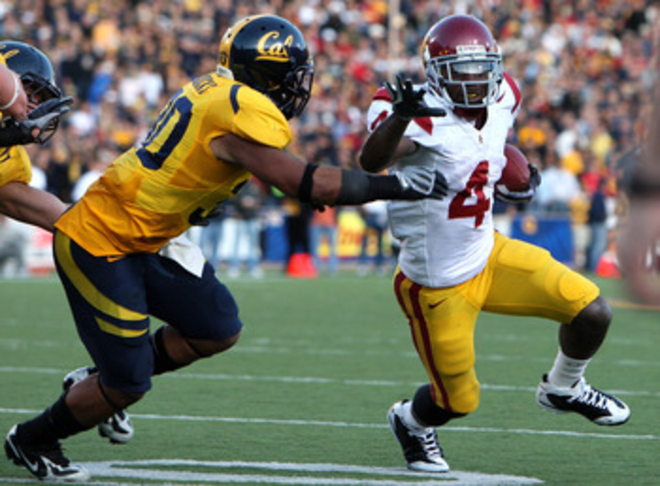 BERKELEY, CA - OCTOBER 03:  Joe McKnight #4 of the USC Trojans runs against Mychal Kendricks #30 of the California Golden Bears at Memorial Stadium on October 3, 2009 in Berkeley, California.  (Photo by Jed Jacobsohn/Getty Images)